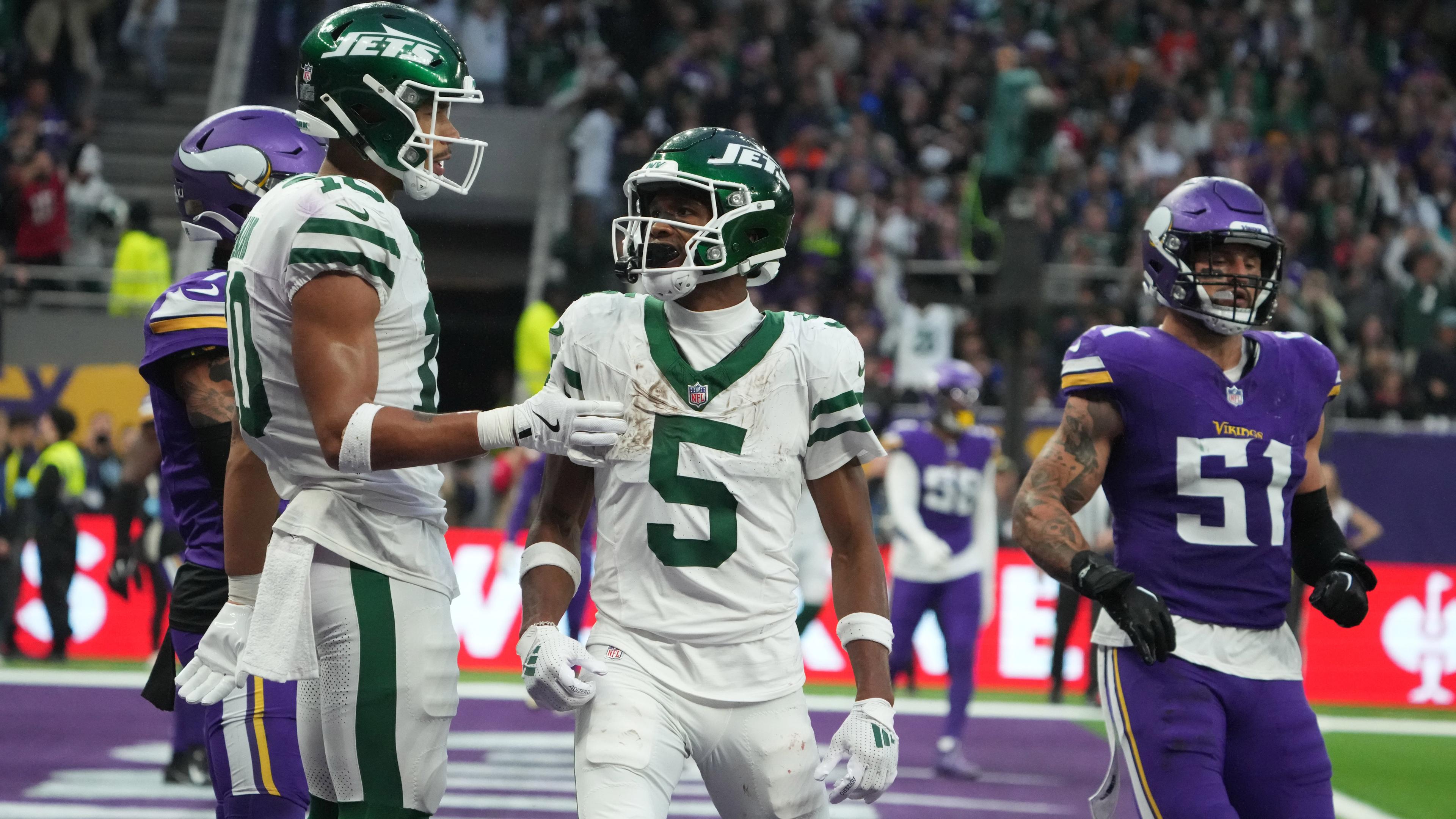 Oct 6, 2024; London, United Kingdom; New York Jets wide receiver Garrett Wilson (5) celebrates with wide receiver Allen Lazard (10) after scoring on a 1-yard touchdown reception against the New York Jets in the fourth quarter at Tottenham Hotspur Stadium. Mandatory Credit: Kirby Lee-Imagn Images