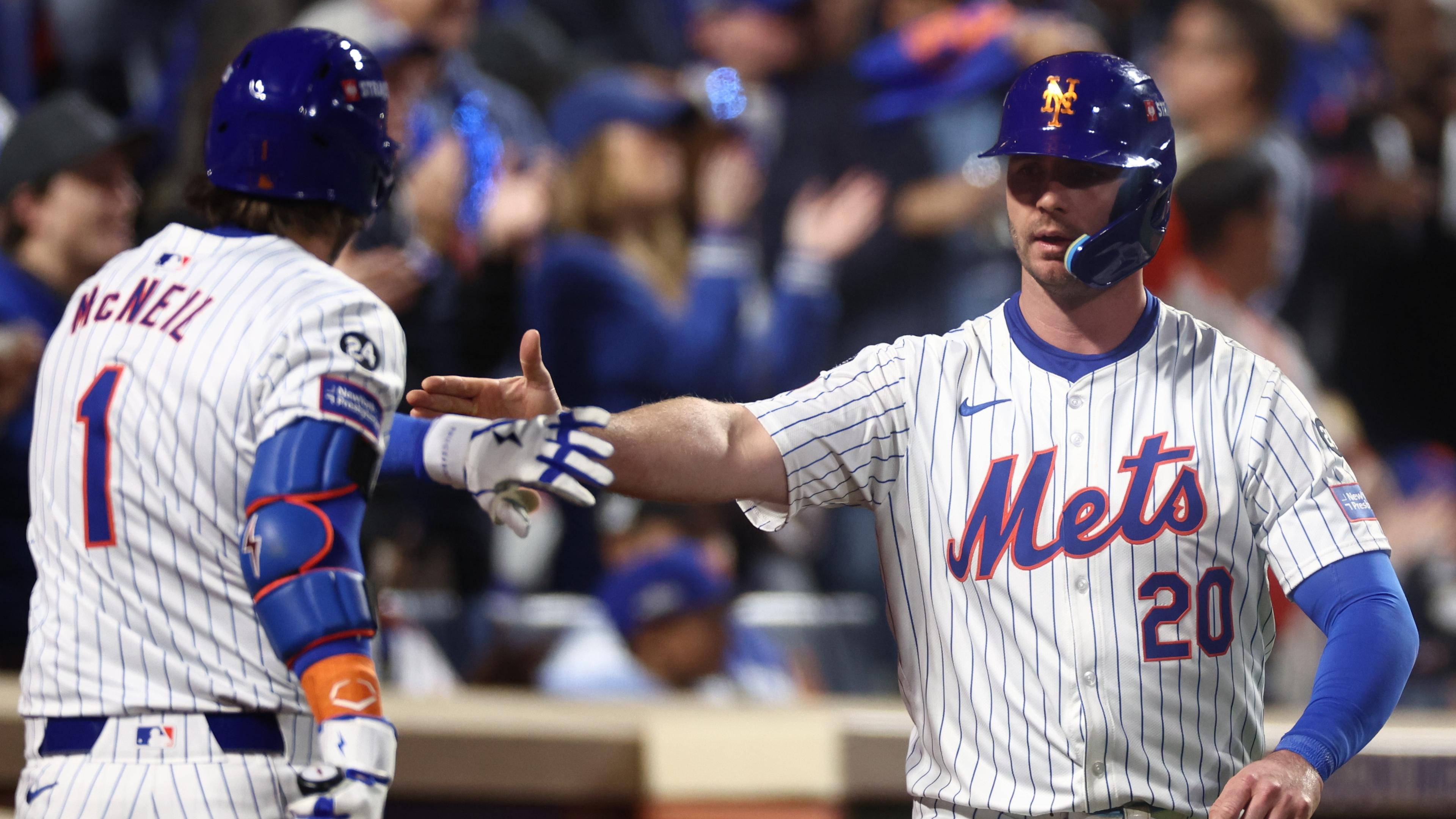 Oct 18, 2024; New York City, New York, USA; New York Mets first baseman Pete Alonso (20) celebrates scoring on an RBI from right fielder Starling Marte (6, not pictured) with New York Mets second baseman Jeff McNeil (1) during the eighth inning against the Los Angeles Dodgers during game five of the NLCS for the 2024 MLB playoffs at Citi Field. 