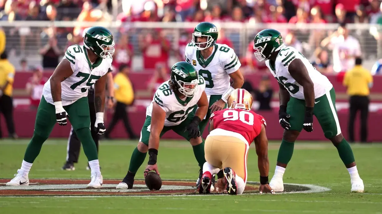 New York Jets quarterback Aaron Rodgers (8) talks with guards Alijah Vera-Tucker (75) and John Simpson (76) and center Joe Tippmann (66) before a snap against the San Francisco 49ers during the first quarter at Levi's Stadium. / Darren Yamashita-Imagn Images