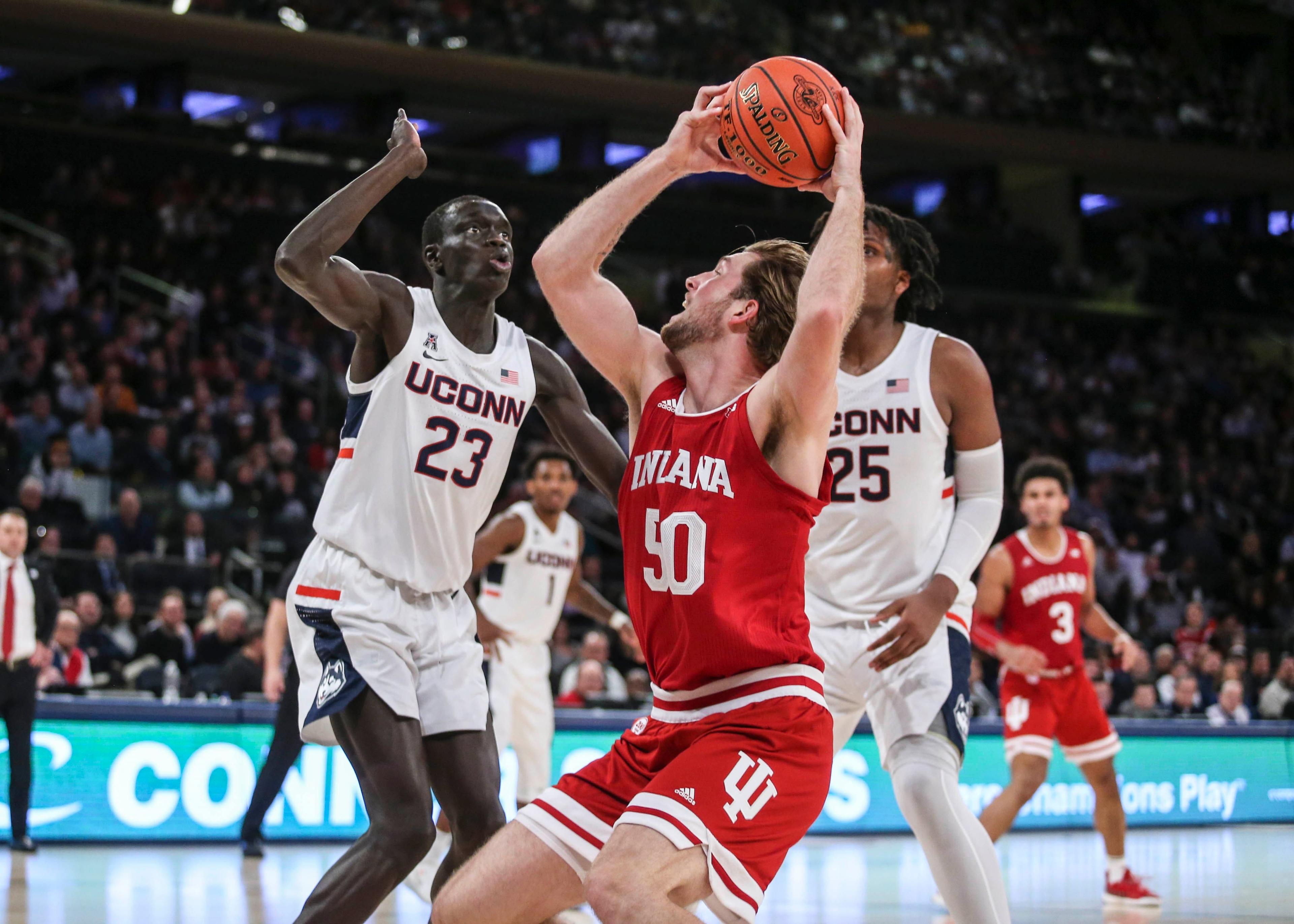 Dec 10, 2019; New York, NY, USA; Indiana Hoosiers forward Joey Brunk (50) puts up a shot against Connecticut Huskies forward Akok Akok (23) in the second half at Madison Square Garden. Mandatory Credit: Wendell Cruz-USA TODAY Sports / Wendell Cruz