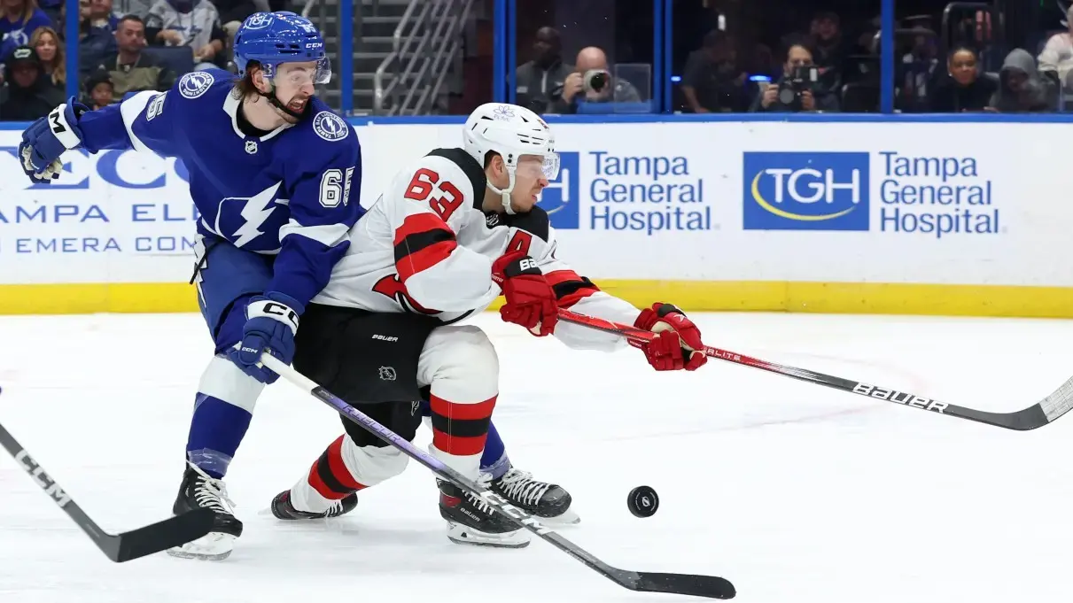 Tampa Bay Lightning defenseman Maxwell Crozier (65) defends New Jersey Devils left wing Jesper Bratt (63) during the second period at Amalie Arena. / Kim Klement Neitzel-USA TODAY Sports