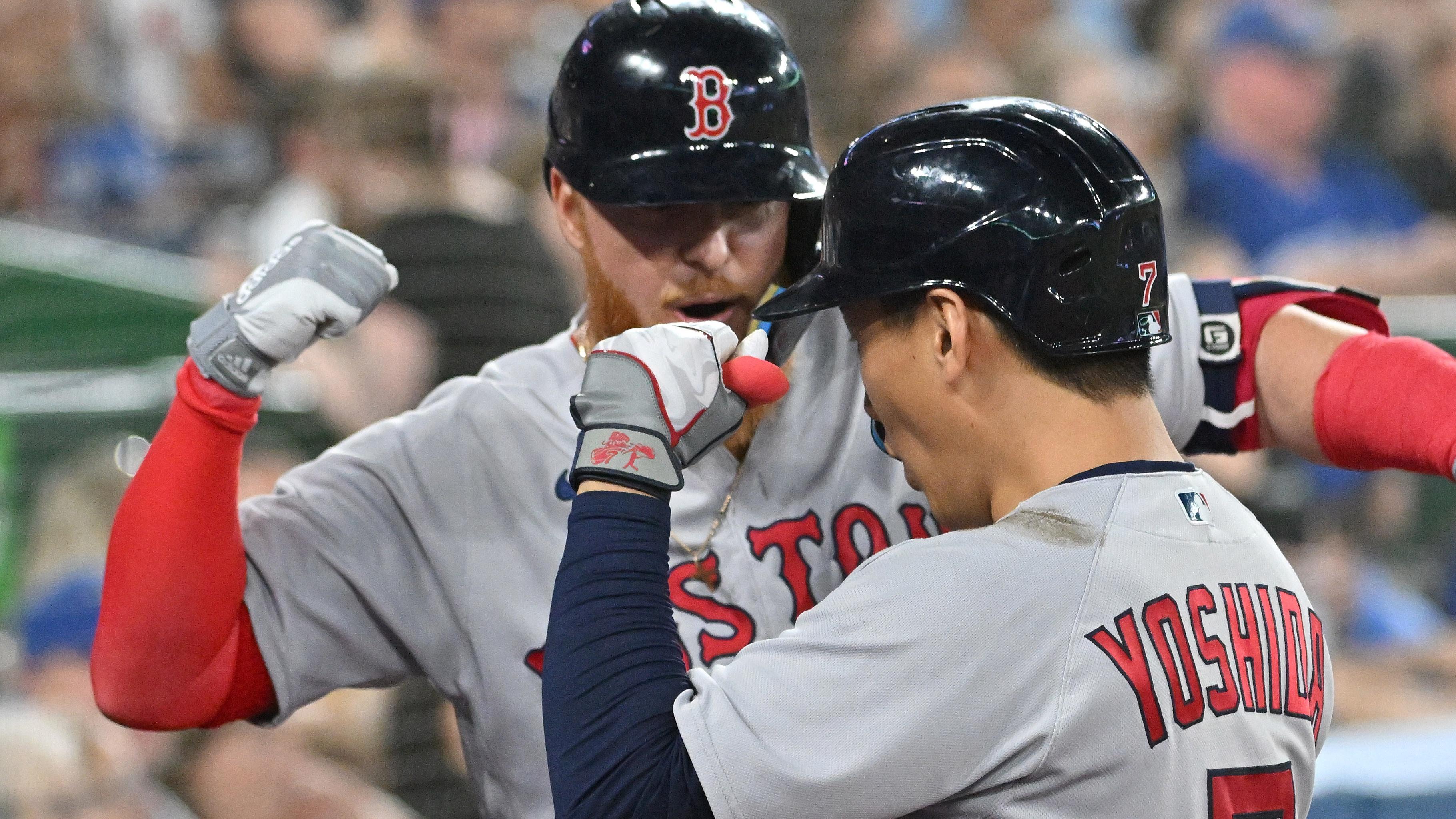Boston Red Sox left fielder Masataka Yoshida (7) is greeted by designated hitter Justin Turner (2) after hitting a solo home run against the Toronto Blue Jays in the sixth inning at Rogers Centre / Dan Hamilton - USA TODAY Sports