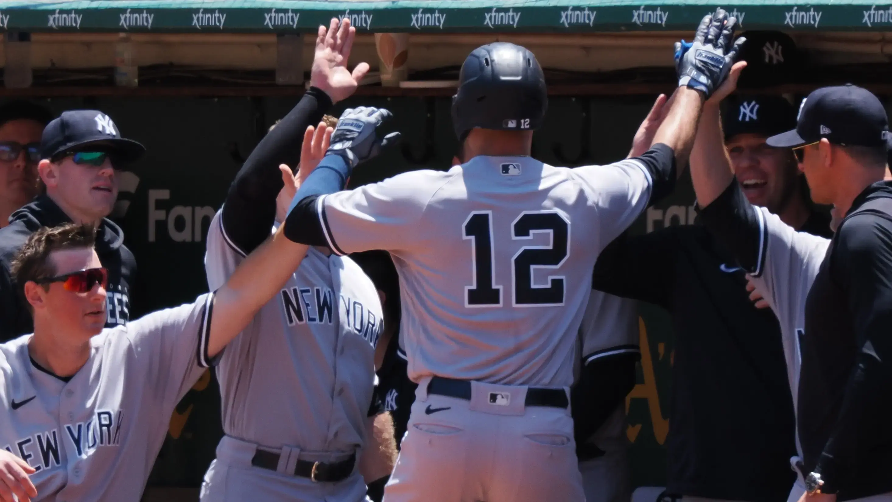 New York Yankees left fielder Isiah Kiner-Falefa (12) high fives teammates after hitting a solo home run against the Oakland Athletics during the second inning at Oakland-Alameda County Coliseum / Kelley L Cox - USA TODAY Sports