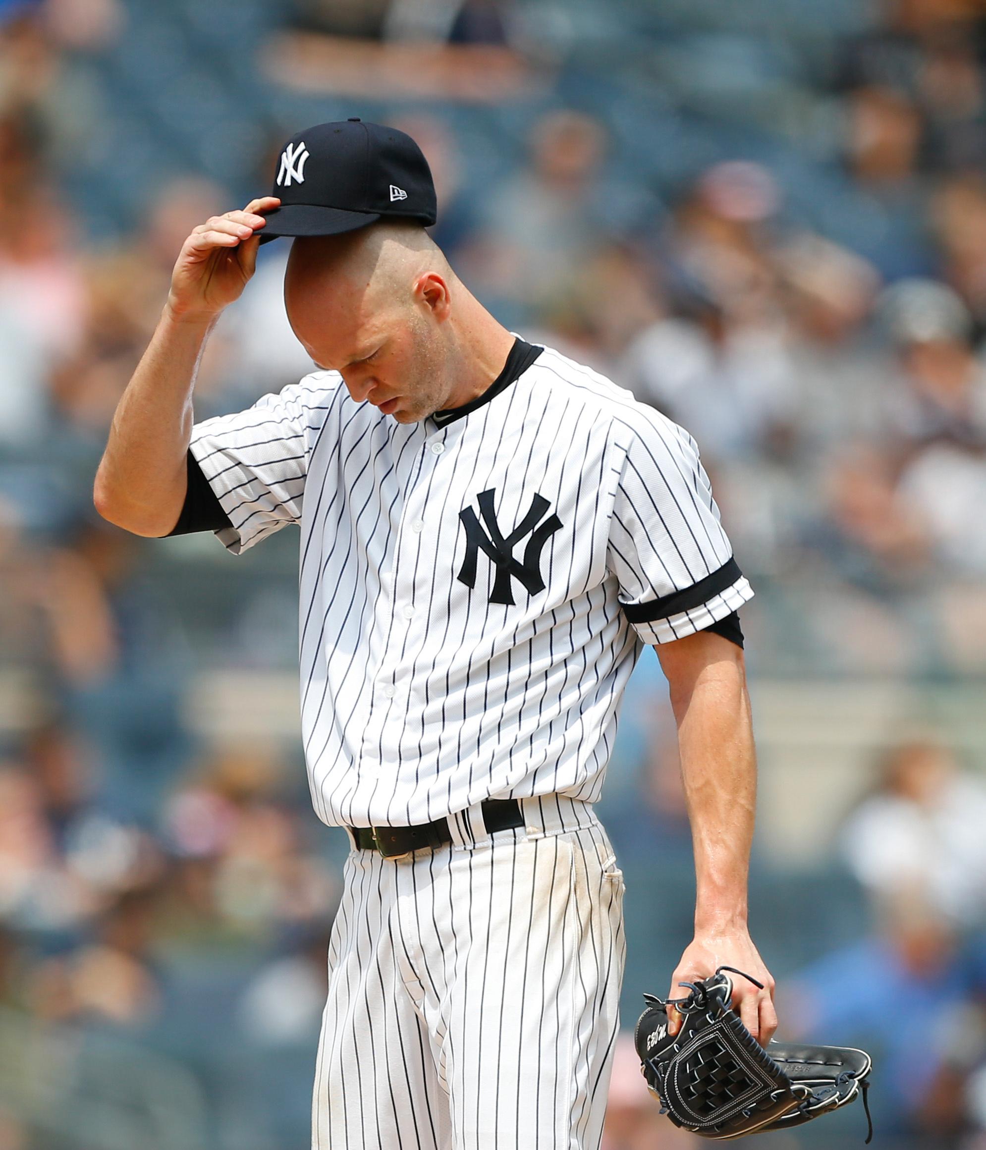 Aug 14, 2019; Bronx, NY, USA; New York Yankees starting pitcher J.A. Happ (34) pauses before pitching against the Baltimore Orioles in the first inning at Yankee Stadium. Mandatory Credit: Noah K. Murray-USA TODAY Sports