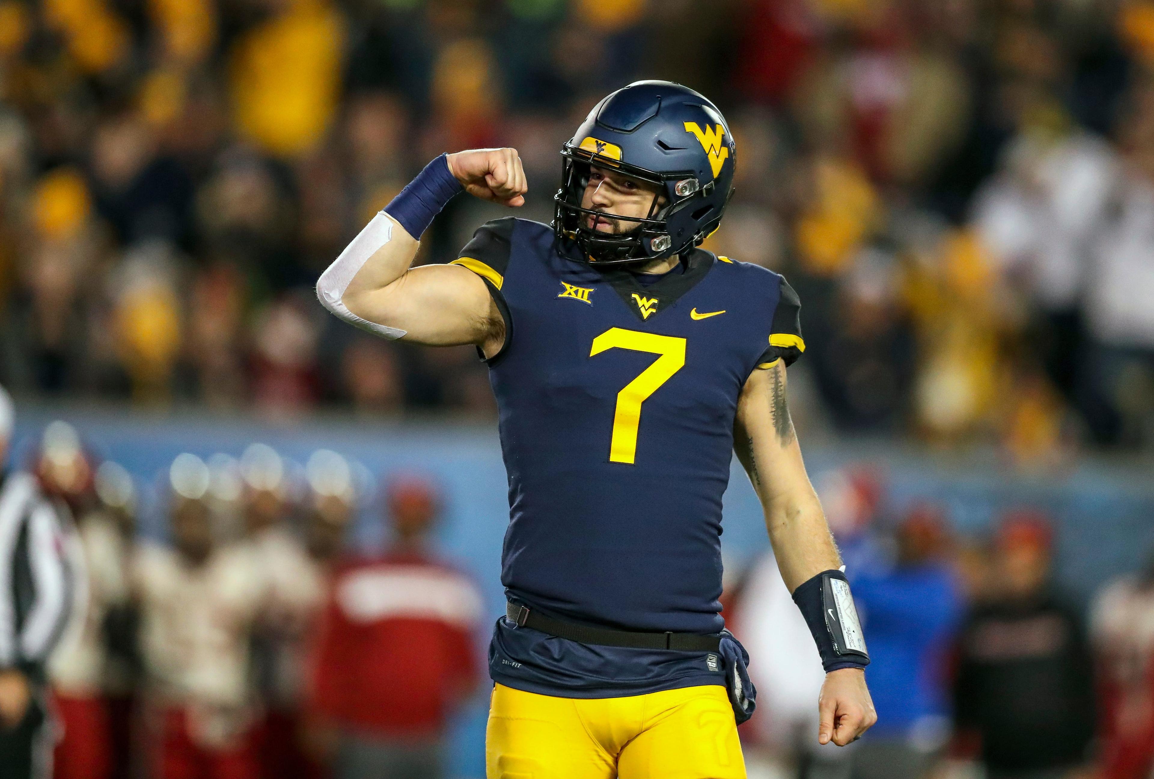 Nov 23, 2018; Morgantown, WV, USA; West Virginia Mountaineers quarterback Will Grier (7) celebrates during the second quarter against the Oklahoma Sooners at Mountaineer Field at Milan Puskar Stadium. Mandatory Credit: Ben Queen-USA TODAY Sports / Ben Queen