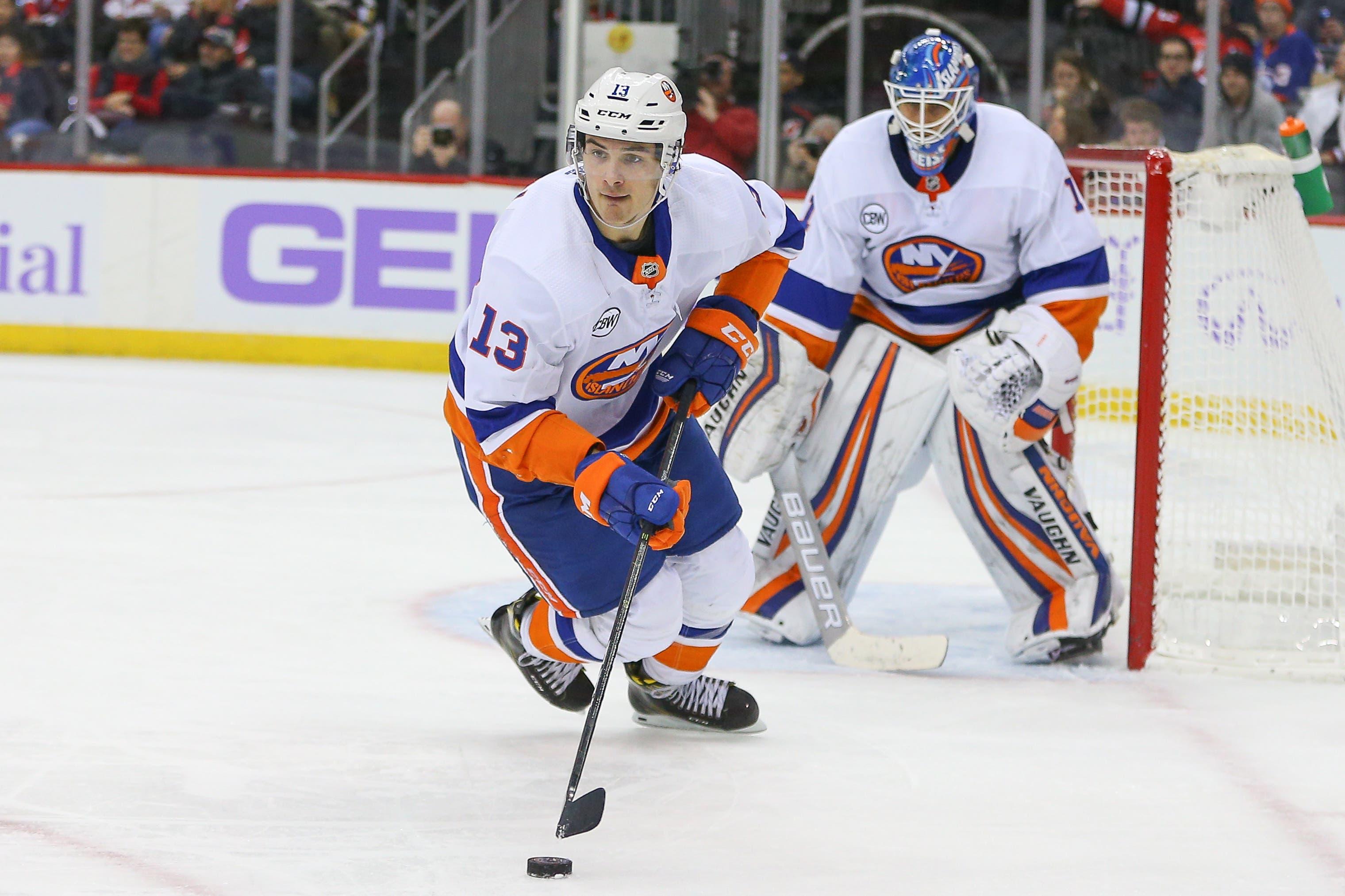 Nov 23, 2018; Newark, NJ, USA; New York Islanders center Mathew Barzal (13) skates with the puck in front of goaltender Thomas Greiss (1) during the second period against the New Jersey Devils at Prudential Center. Mandatory Credit: Vincent Carchietta-USA TODAY Sports / Vincent Carchietta