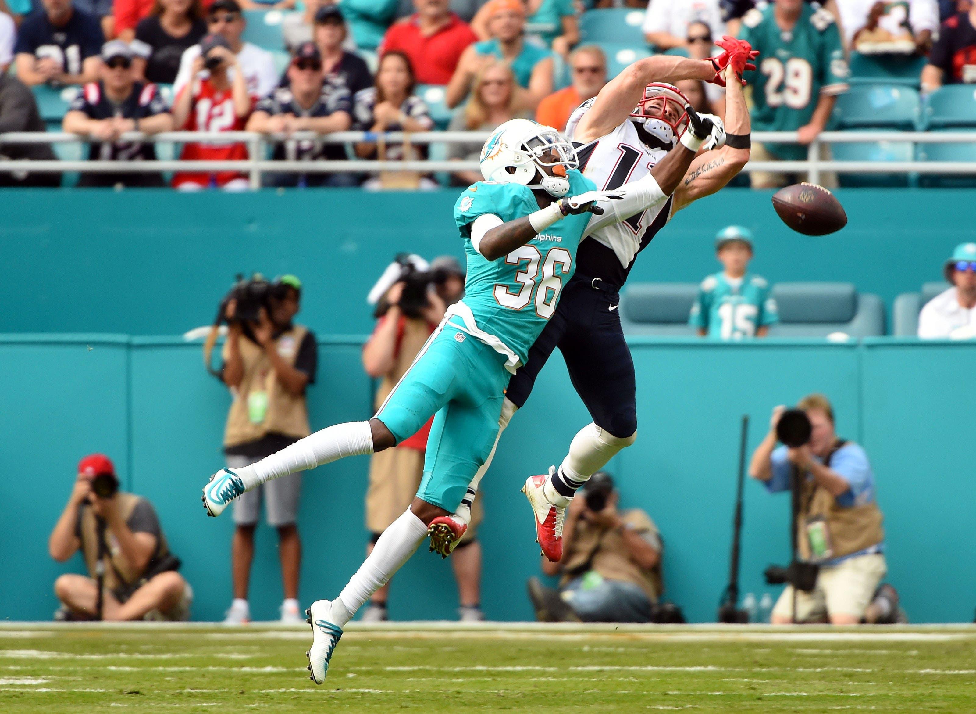 New England Patriots wide receiver Julian Edelman is unable to make a catch as Miami Dolphins cornerback Tony Lippett defends the play during the first half at Hard Rock Stadium. / Steve Mitchell/USA TODAY Sports