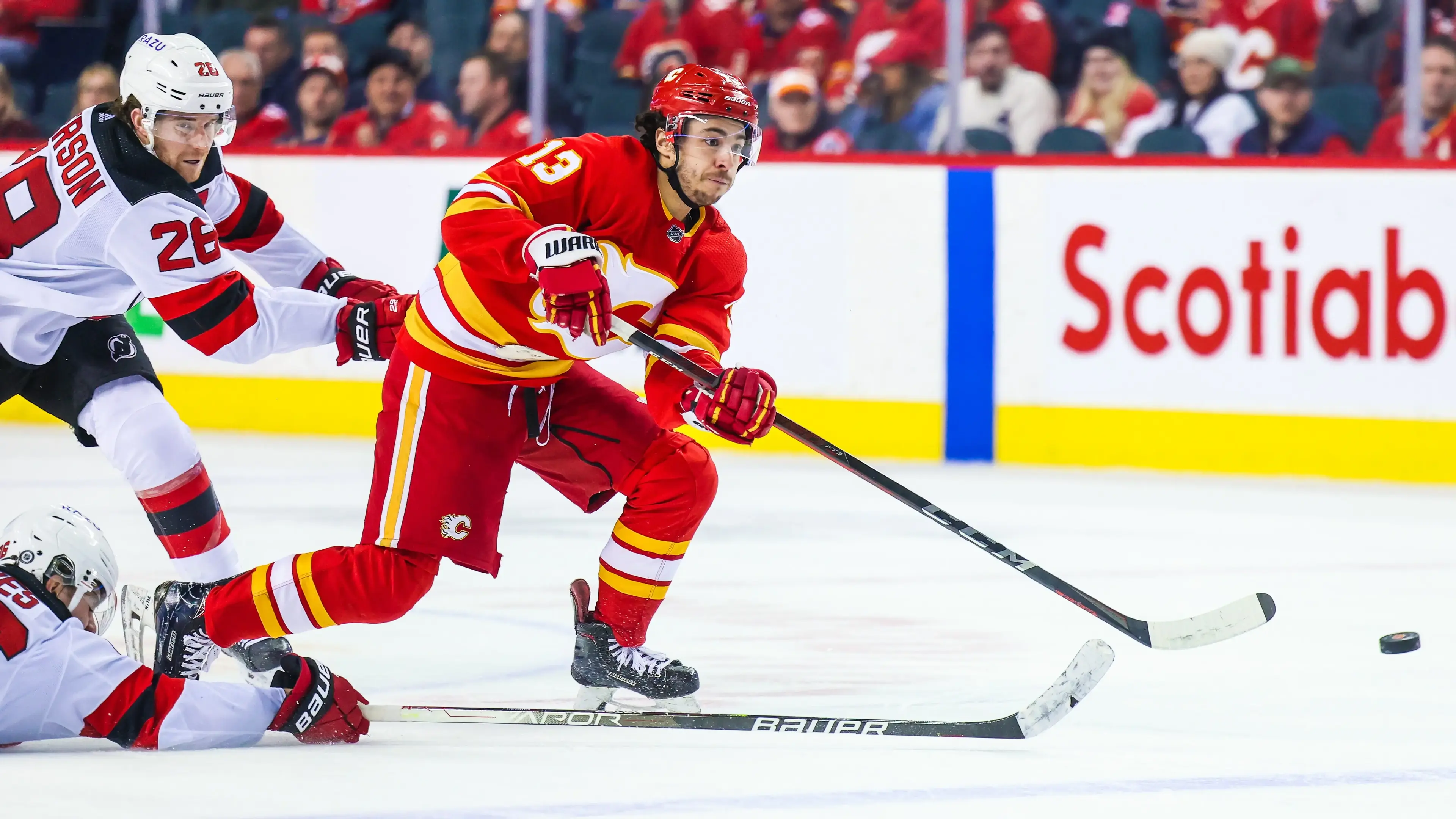 Mar 16, 2022; Calgary, Alberta, CAN; Calgary Flames left wing Johnny Gaudreau (13) scores a goal against the New Jersey Devils during the third period at Scotiabank Saddledome. / Sergei Belski-USA TODAY Sports