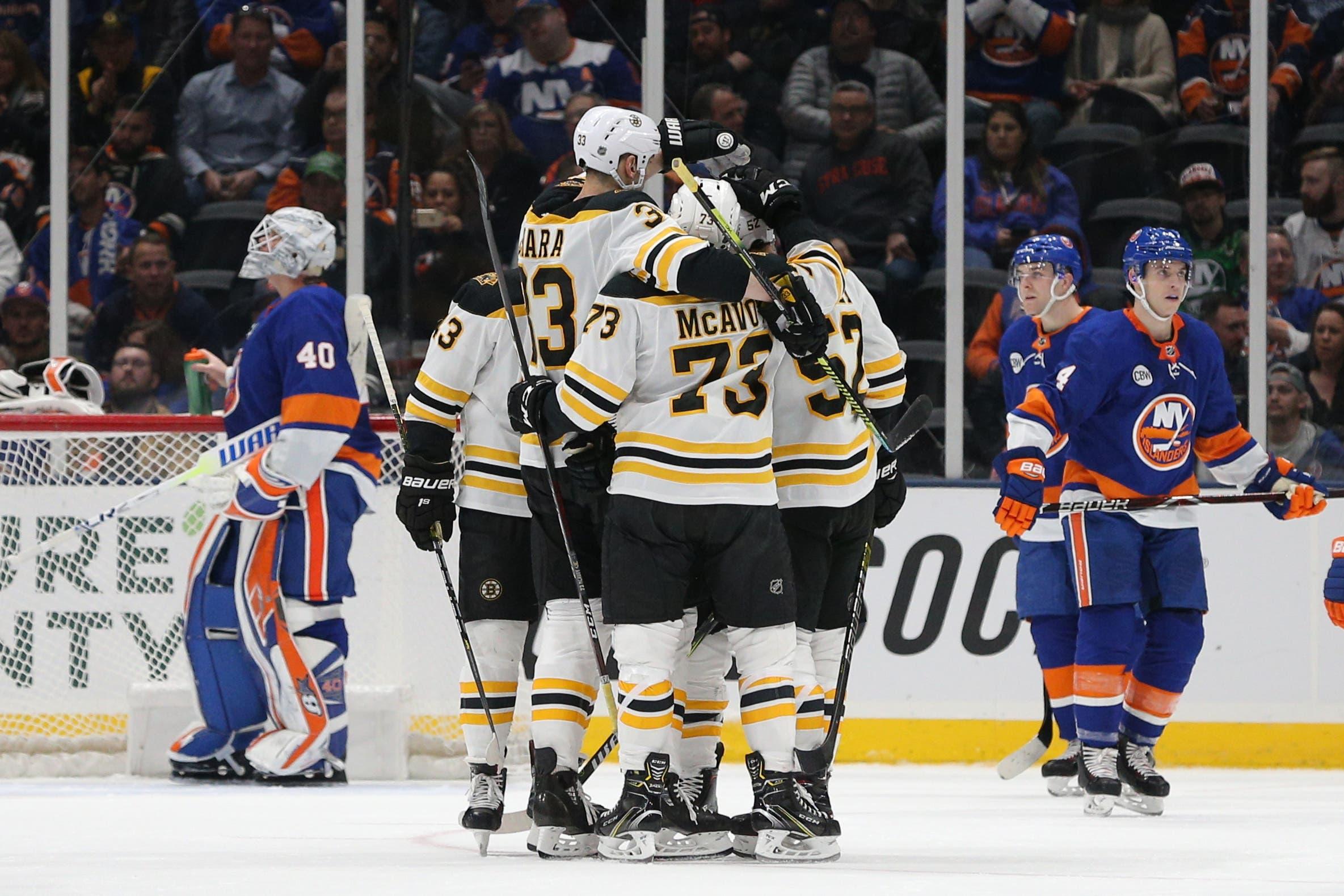 Mar 19, 2019; Uniondale, NY, USA; Boston Bruins center Sean Kuraly (52) celebrates with teammates after scoring a goal against New York Islanders goalie Robin Lehner (40) during the second period at Nassau Veterans Memorial Coliseum. Mandatory Credit: Brad Penner-USA TODAY Sports / Brad Penner