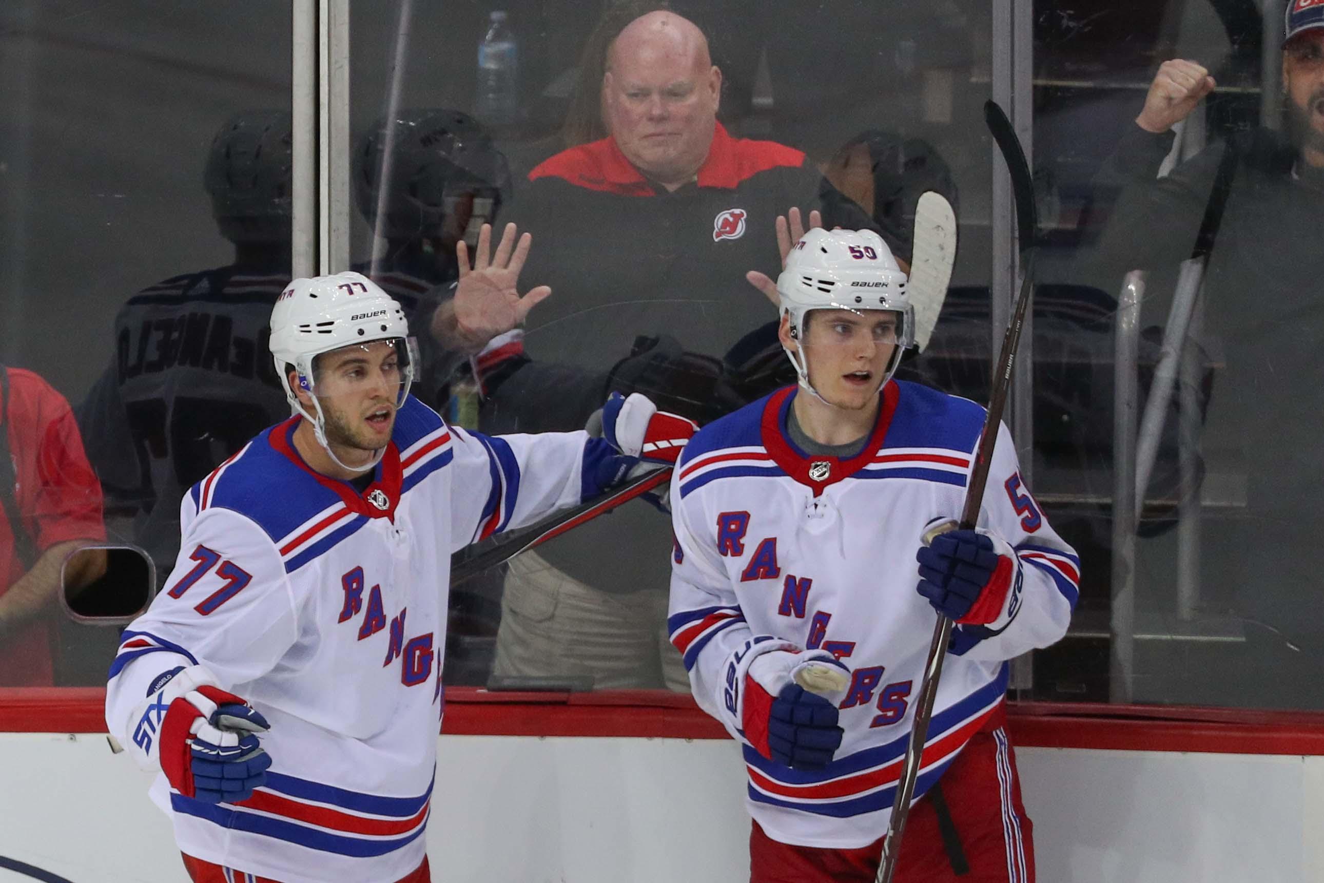 Sep 17, 2018; Newark, NJ, USA; New York Rangers center Lias Andersson (50) celebrates his goal with New York Rangers defenseman Tony DeAngelo (77) during the third period of their game against the New Jersey Devils at Prudential Center. Mandatory Credit: Ed Mulholland-USA TODAY Sports / Ed Mulholland