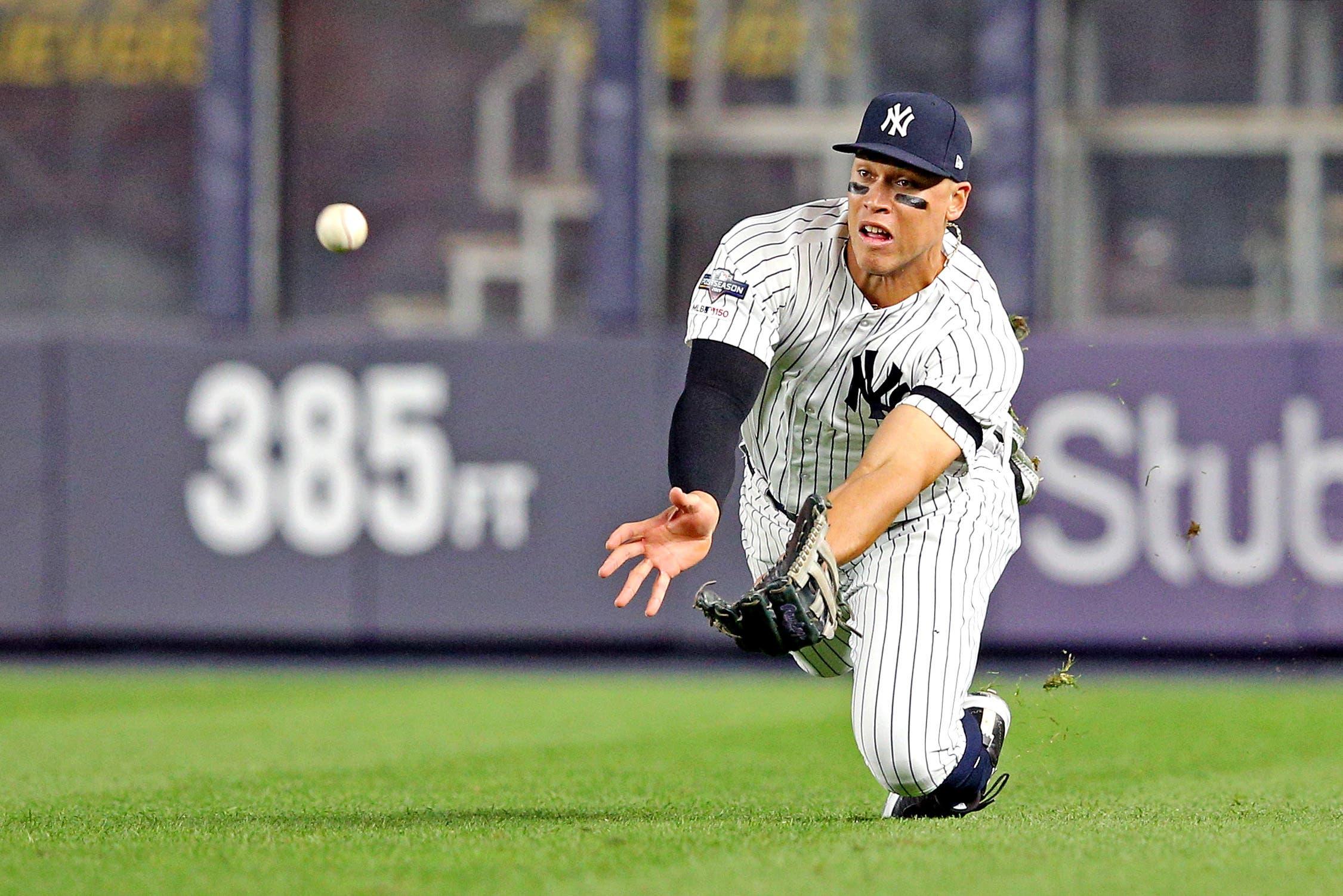 Oct 4, 2019; Bronx, NY, USA; New York Yankees right fielder Aaron Judge (99) makes a diving catch during the third inning in game one of the 2019 ALDS playoff baseball series at Yankee Stadium. Mandatory Credit: Brad Penner-USA TODAY Sports / Brad Penner