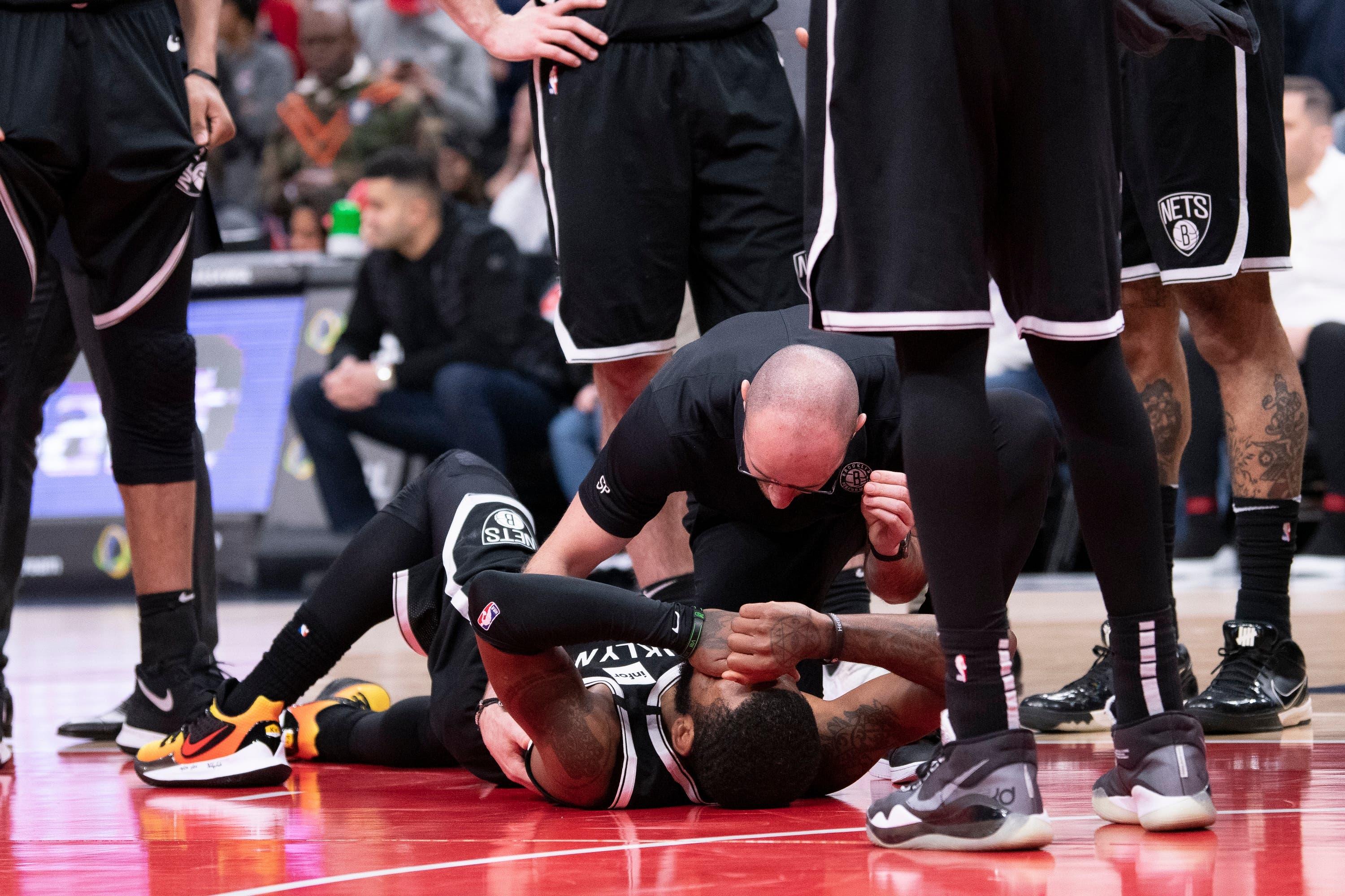 Feb 1, 2020; Washington, District of Columbia, USA; Brooklyn Nets staff tends to guard Kyrie Irving (11) during the second half against the Washington Wizards at Capital One Arena. Mandatory Credit: Tommy Gilligan-USA TODAY Sports / Tommy Gilligan