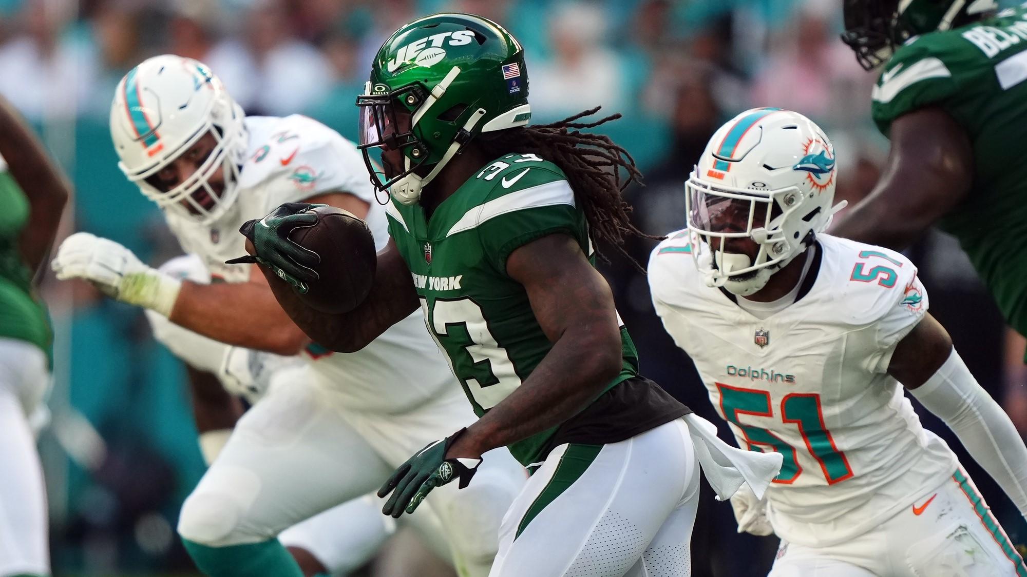 Dec 17, 2023; Miami Gardens, Florida, USA; New York Jets running back Dalvin Cook (33) rushes with the ball against the Miami Dolphins during the first half at Hard Rock Stadium.