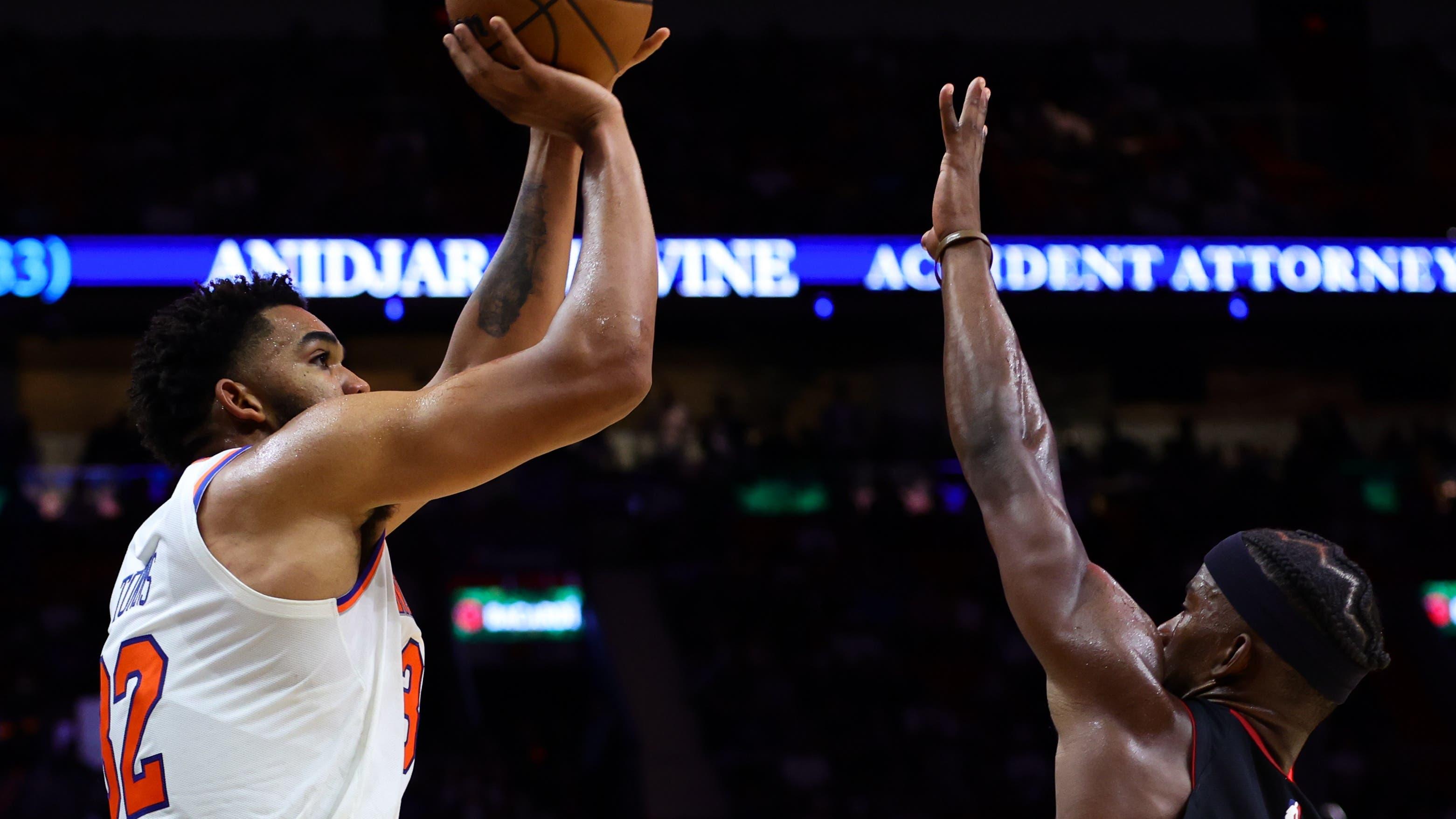 New York Knicks center Karl-Anthony Towns (32) shoots the basketball over Miami Heat forward Jimmy Butler (22) during the fourth quarter at Kaseya Center / Sam Navarro - Imagn Images