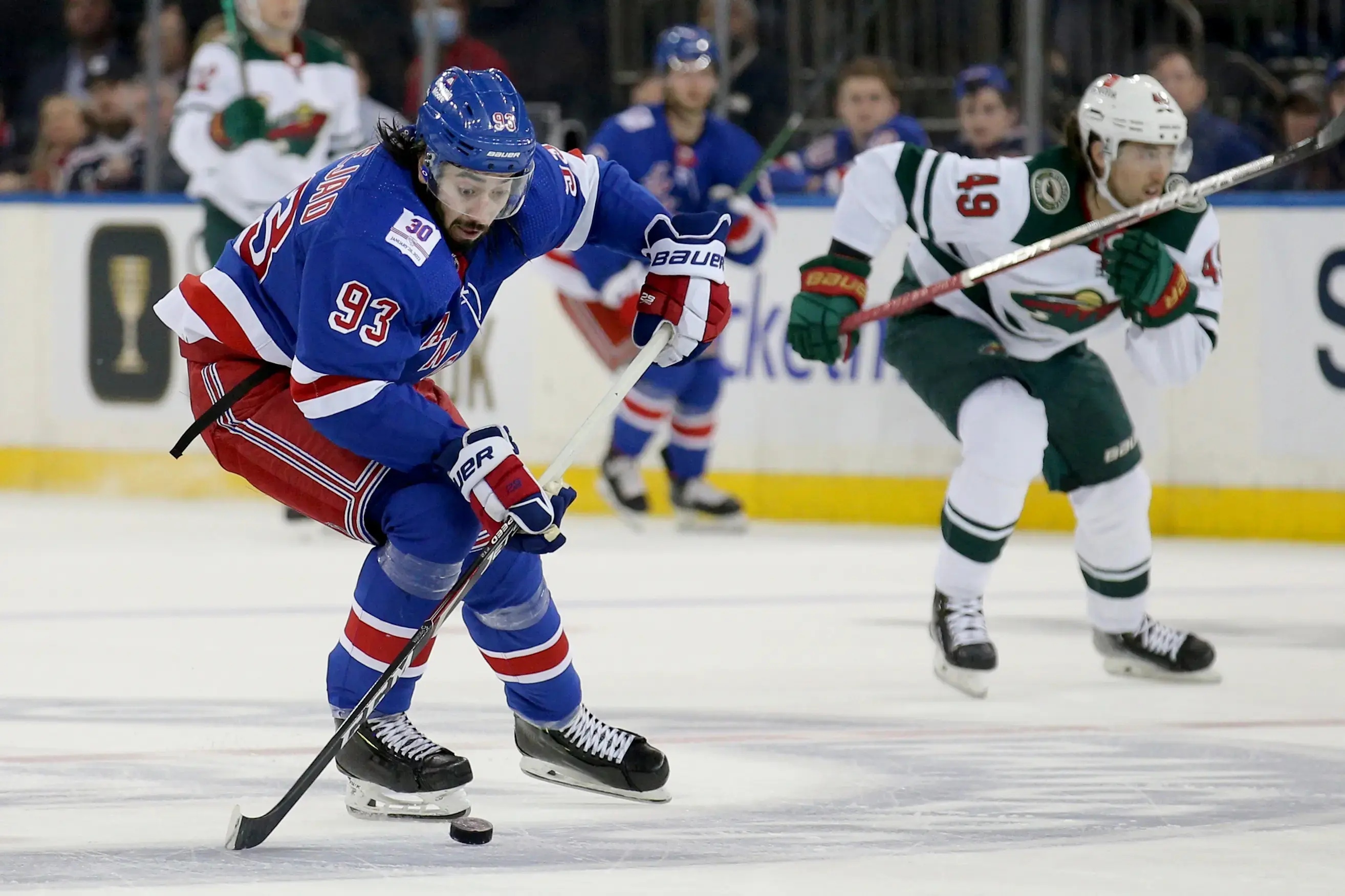 New York Rangers center Mika Zibanejad (93) brings the puck up ice against Minnesota Wild center Victor Rask (49) during the second period at Madison Square Garden. / Brad Penner-USA TODAY Sports