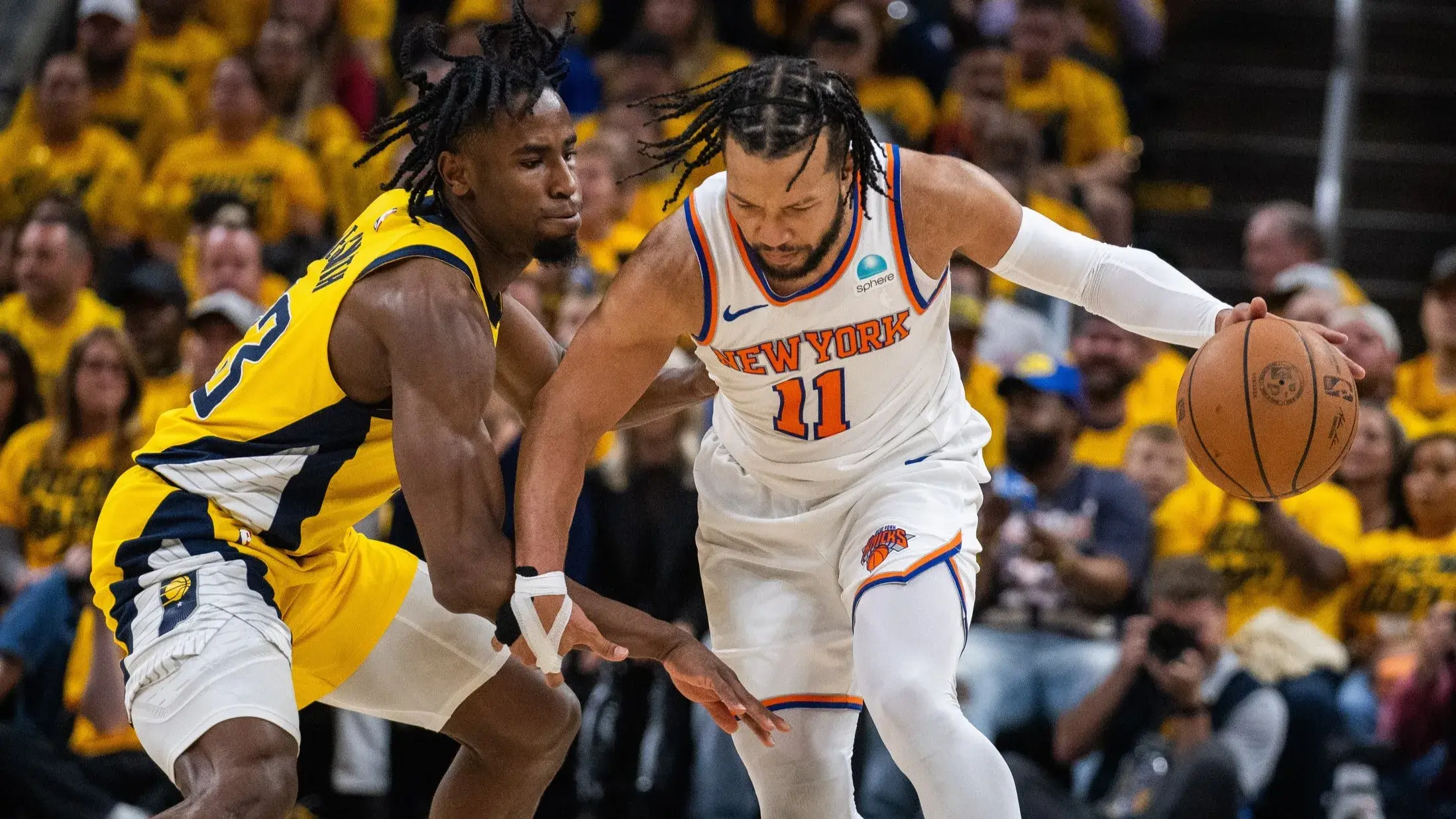 May 10, 2024; Indianapolis, Indiana, USA; New York Knicks guard Jalen Brunson (11) dribbles the ball while Indiana Pacers forward Aaron Nesmith (23) defends during game three of the second round for the 2024 NBA playoffs at Gainbridge Fieldhouse. / Trevor Ruszkowski-USA TODAY Sports