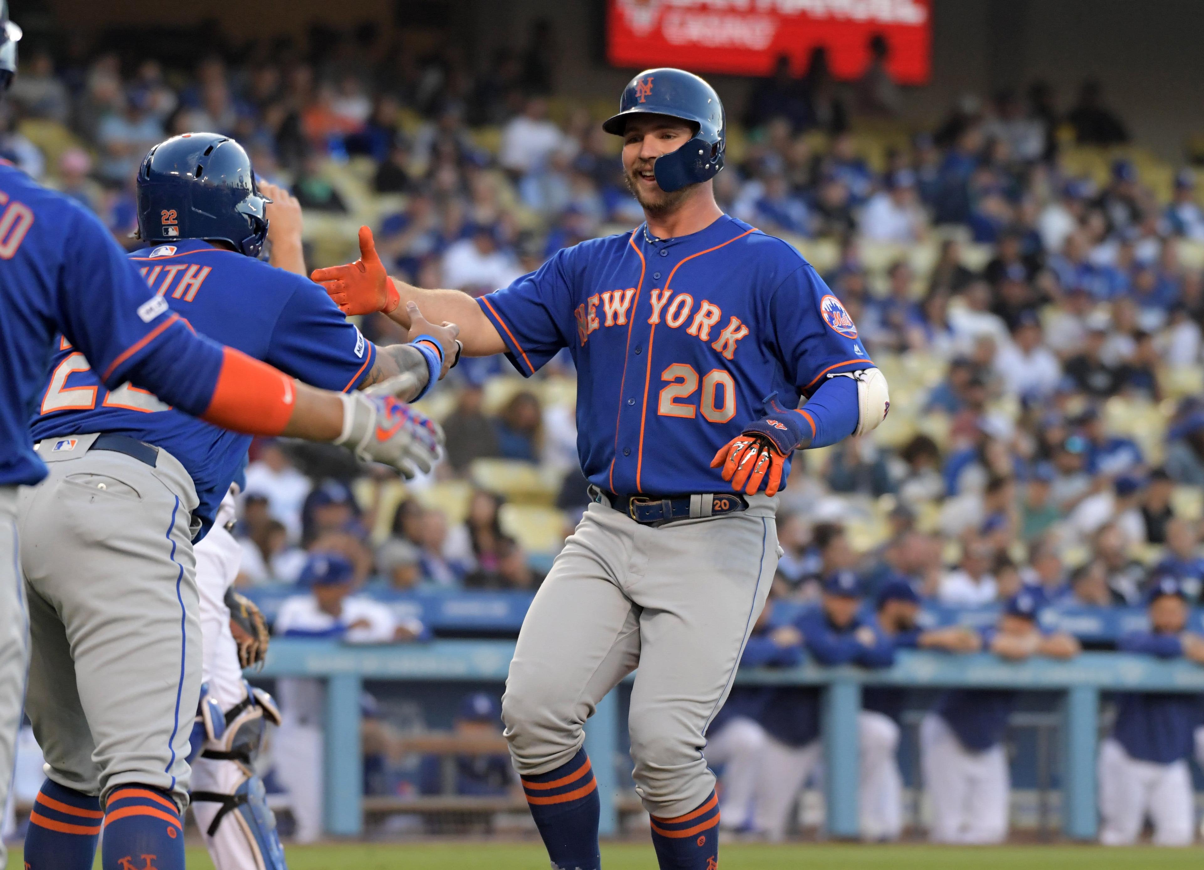 New York Mets first baseman Pete Alonso celebrates with first baseman Dominic Smith after hitting a two-run home run in the first inning against the New York Mets at Dodger Stadium. / Kirby Lee/USA TODAY Sports