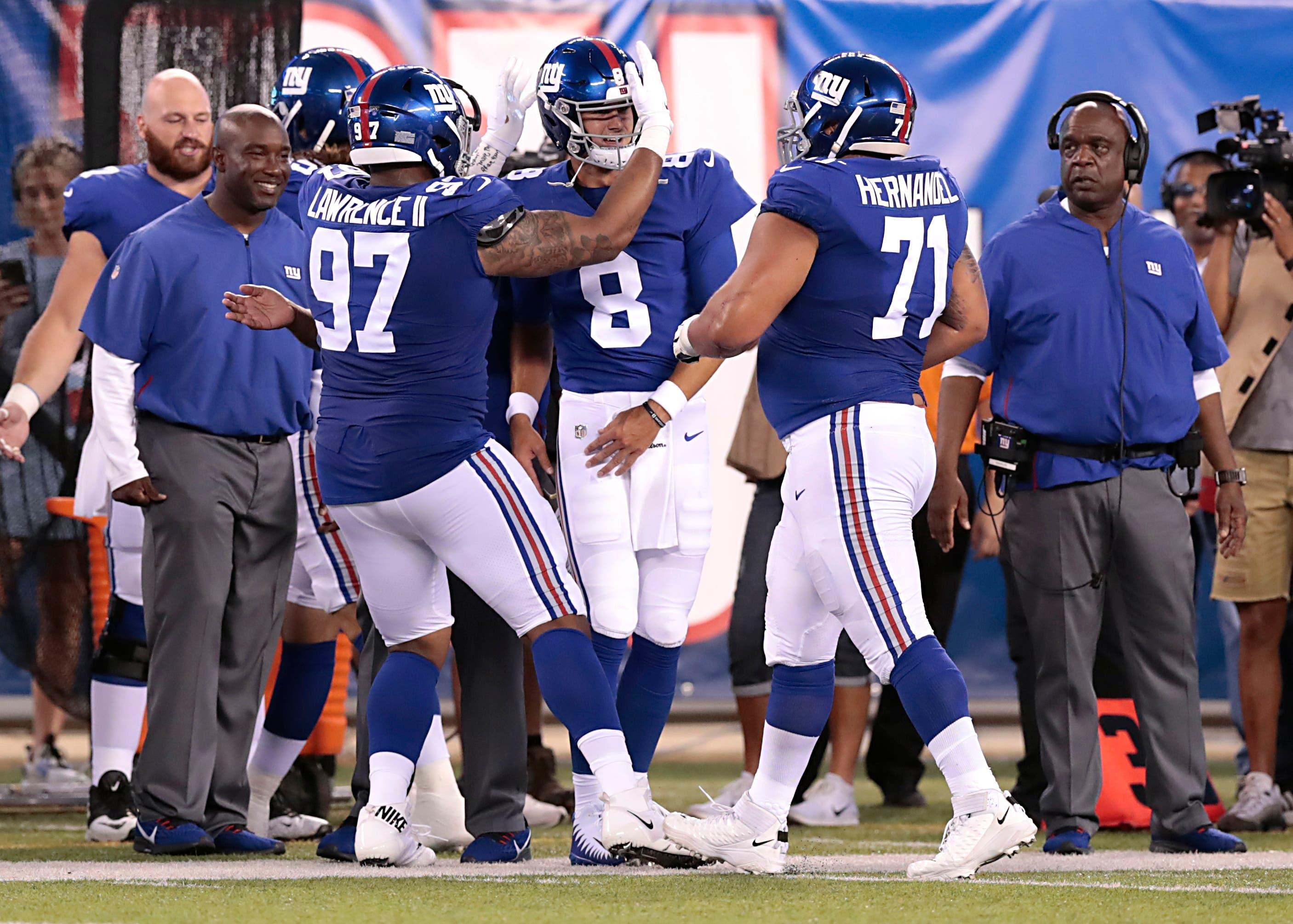 Aug 8, 2019; East Rutherford, NJ, USA; New York Giants quarterback Daniel Jones (8) celebrates after throwing a touchdowns pass with defensive tackle Dexter Lawrence (97) and offensive guard Will Hernandez (71) during the first half against the New York Jets at MetLife Stadium. Mandatory Credit: Vincent Carchietta-USA TODAY Sports / Vincent Carchietta