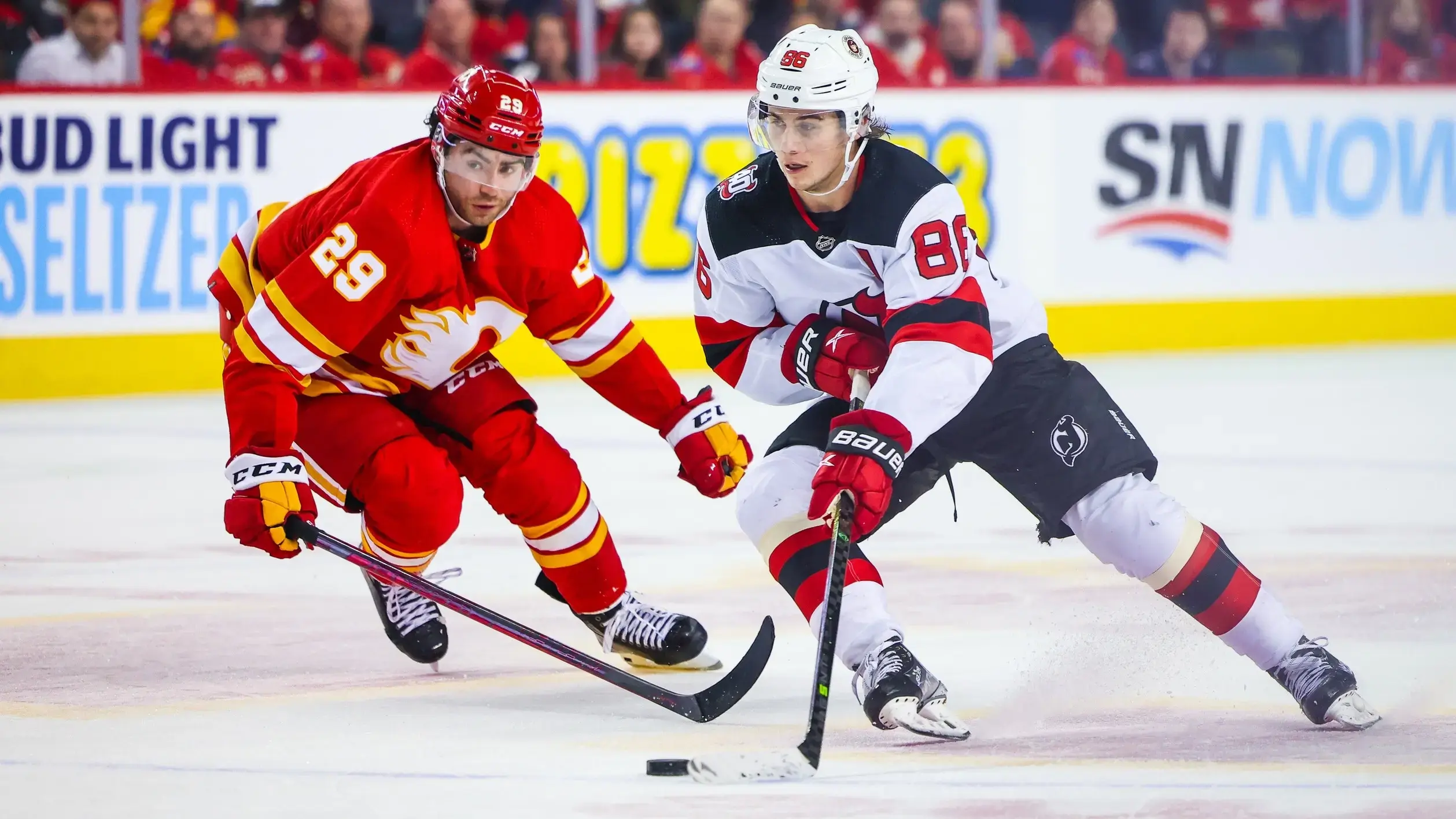 Nov 5, 2022; Calgary, Alberta, CAN; New Jersey Devils center Jack Hughes (86) controls the puck against Calgary Flames center Dillon Dube (29) during the third period at Scotiabank Saddledome. / Sergei Belski-USA TODAY Sports