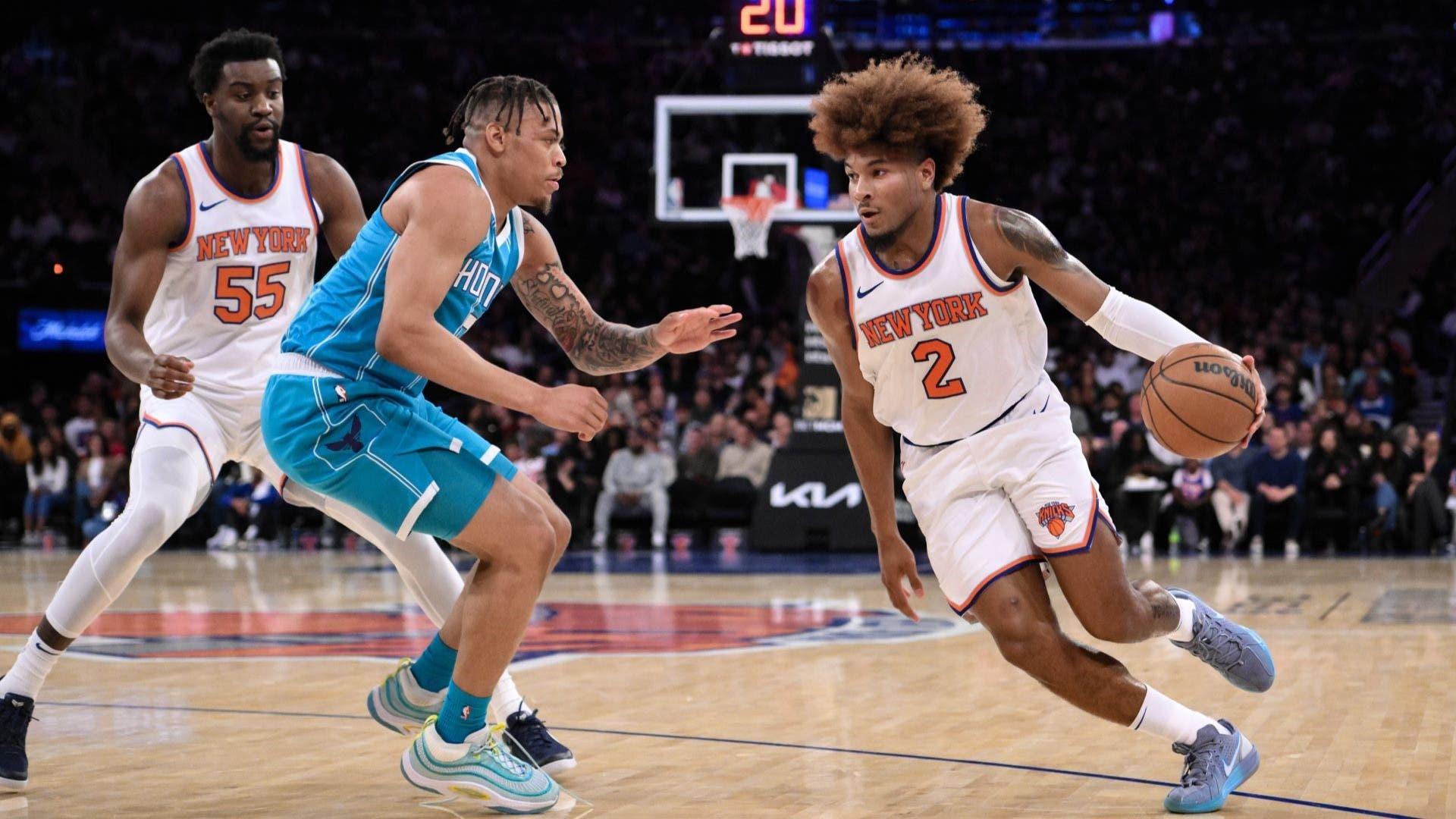 Oct 15, 2024; New York, New York, USA; New York Knicks guard Miles McBride (2) drives to the basket while being defended by Charlotte Hornets forward Keyontae Johnson (7) during the first half at Madison Square Garden. 