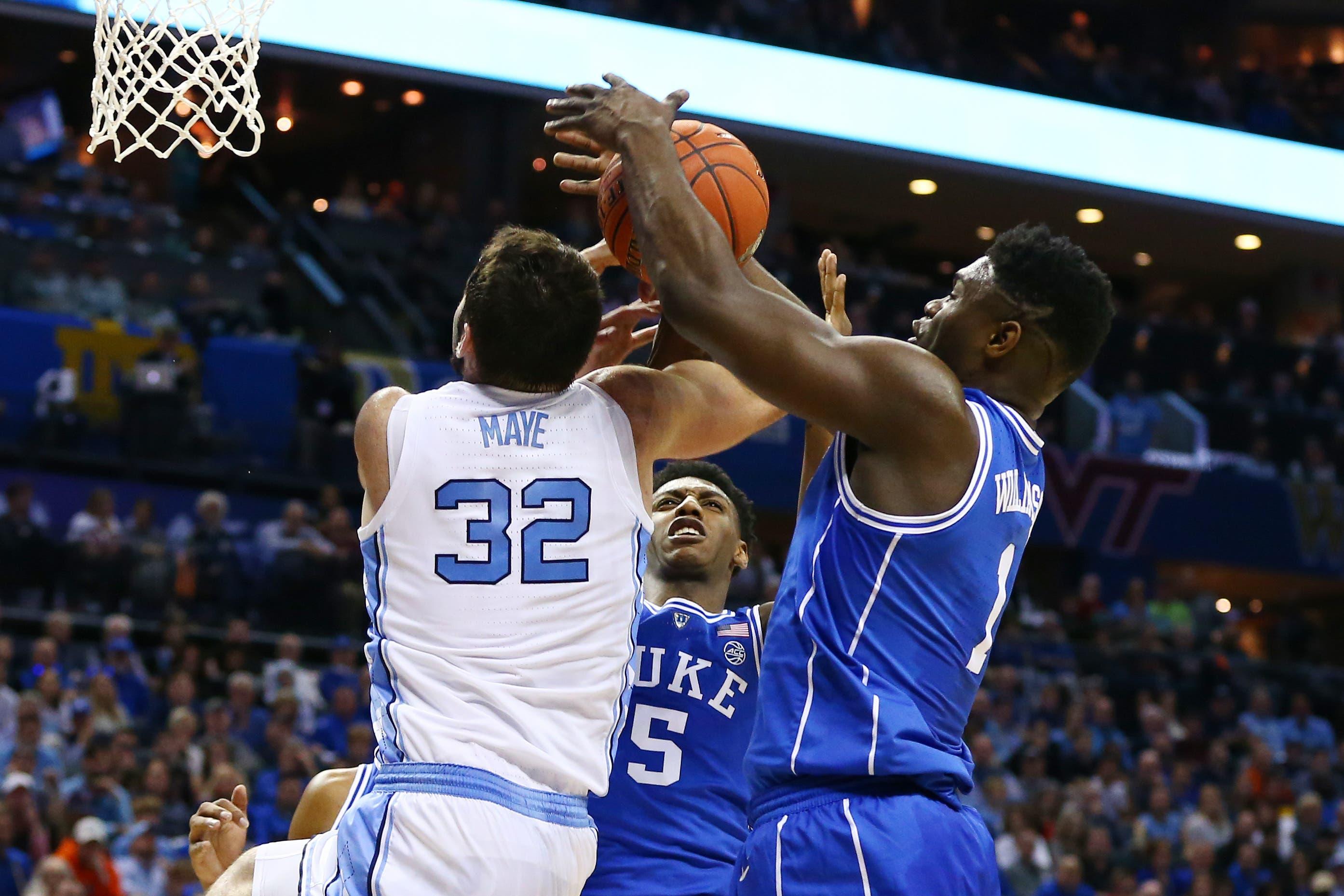 Mar 15, 2019; Charlotte, NC, USA; Duke Blue Devils forward Zion Williamson (1) pulls a rebound away from North Carolina Tar Heels forward Luke Maye (32) in the first half in the ACC conference tournament at Spectrum Center. Mandatory Credit: Jeremy Brevard-USA TODAY Sports / Jeremy Brevard