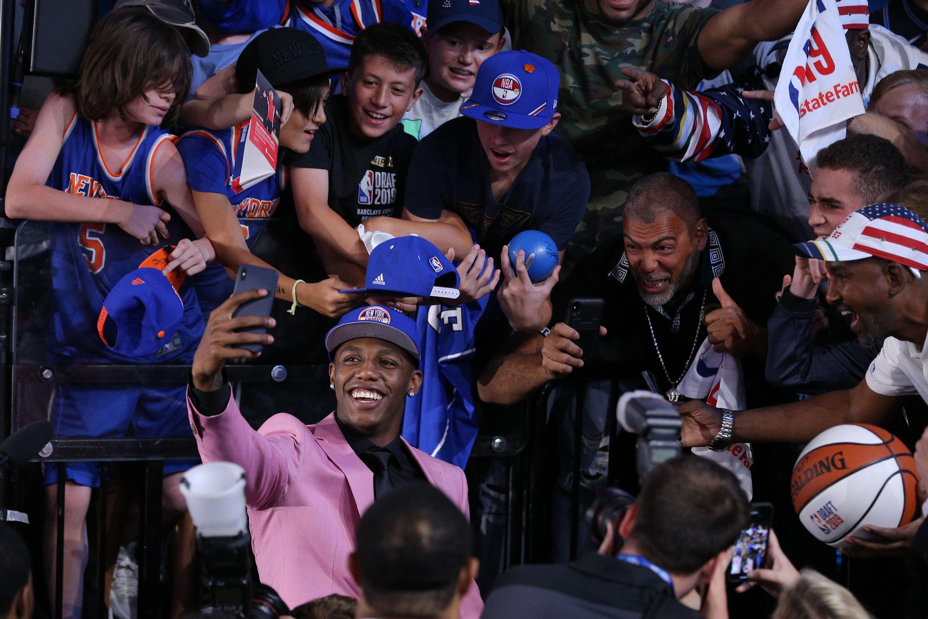 RJ Barrett takes a selfie with fans in the stands after being selected as the No. 3 overall pick to the New York Knicks in the first round of the 2019 NBA Draft at Barclays Center. / Brad Penner/USA TODAY Sports