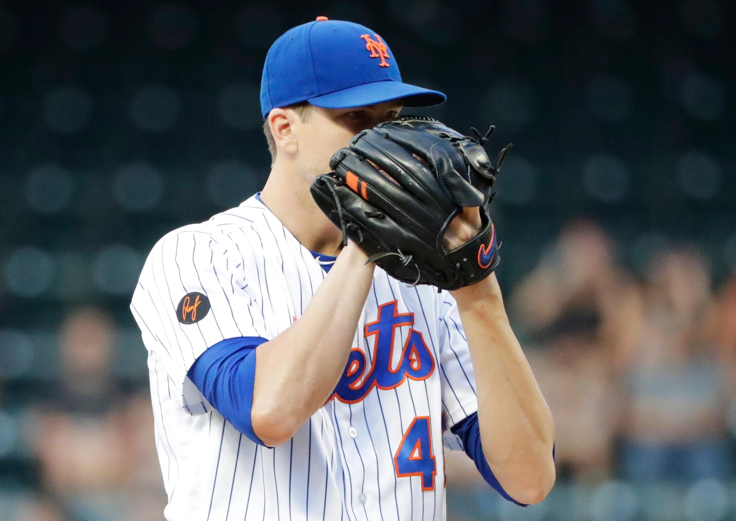 New York Mets starting pitcher Jacob deGrom waits for a signal before delivering a pitch during the first inning of a baseball game against the Philadelphia Phillies Wednesday, July 11, 2018, in New York. (AP Photo/Frank Franklin II)