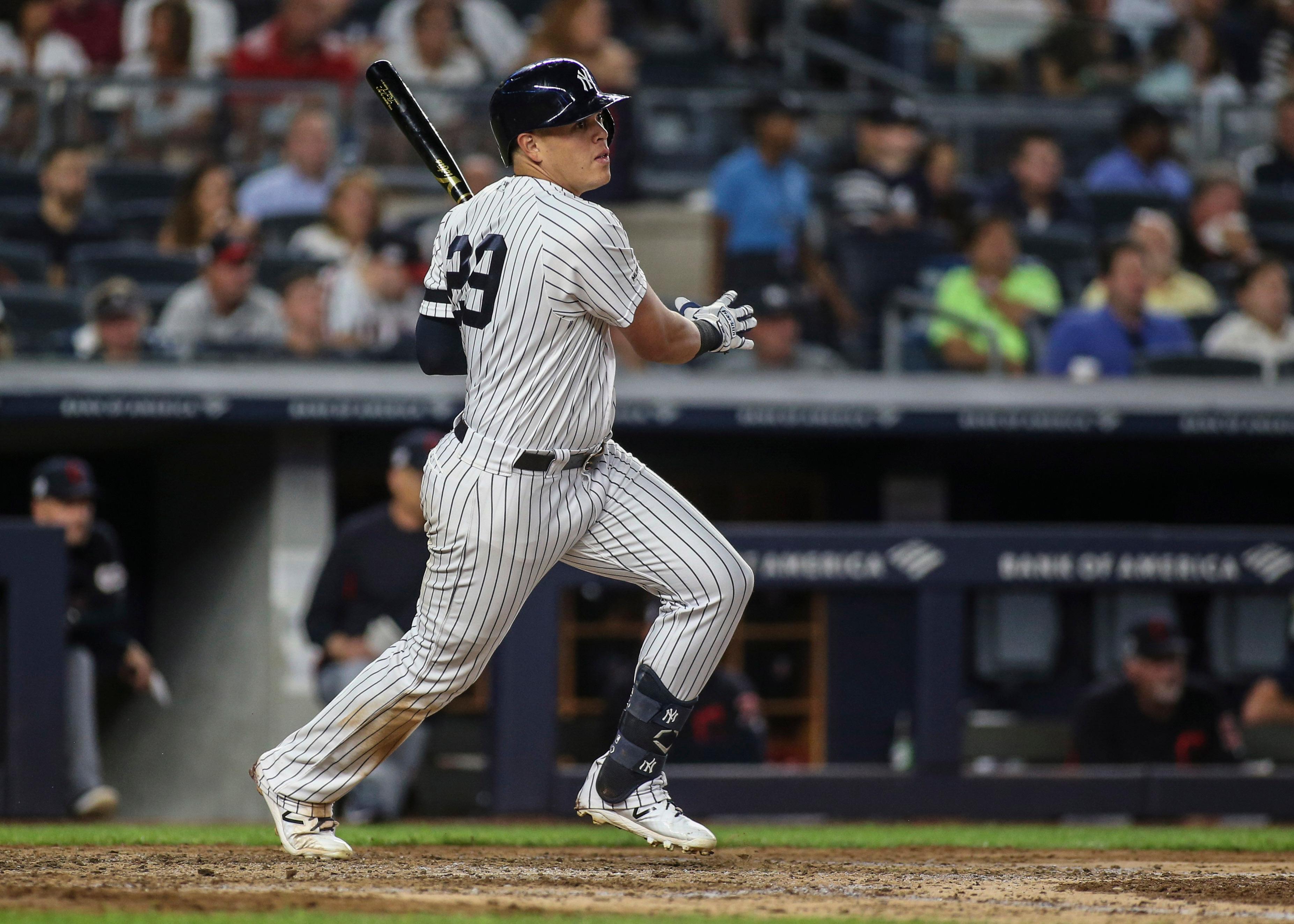 Aug 16, 2019; Bronx, NY, USA; New York Yankees designated hitter Gio Urshela (29) hits an RBI single in the fifth inning against the Cleveland Indians at Yankee Stadium. Mandatory Credit: Wendell Cruz-USA TODAY Sports