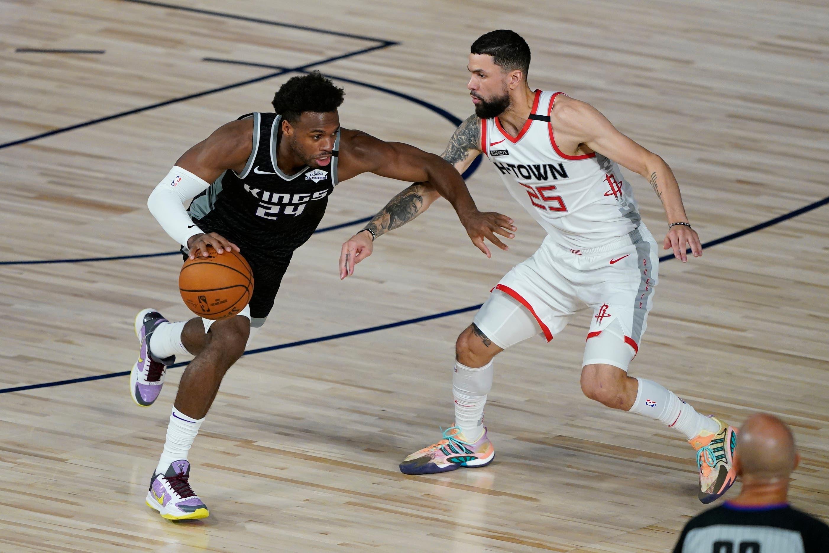 Aug 9, 2020; Lake Buena Vista, Florida, USA; Sacramento Kings' Buddy Hield (24) drives around Houston Rockets' Austin Rivers (25) during the second half of an NBA basketball game Sunday, Aug. 9, 2020, in Lake Buena Vista, Fla. / Ashley Landis/Pool Photo-USA TODAY Sports