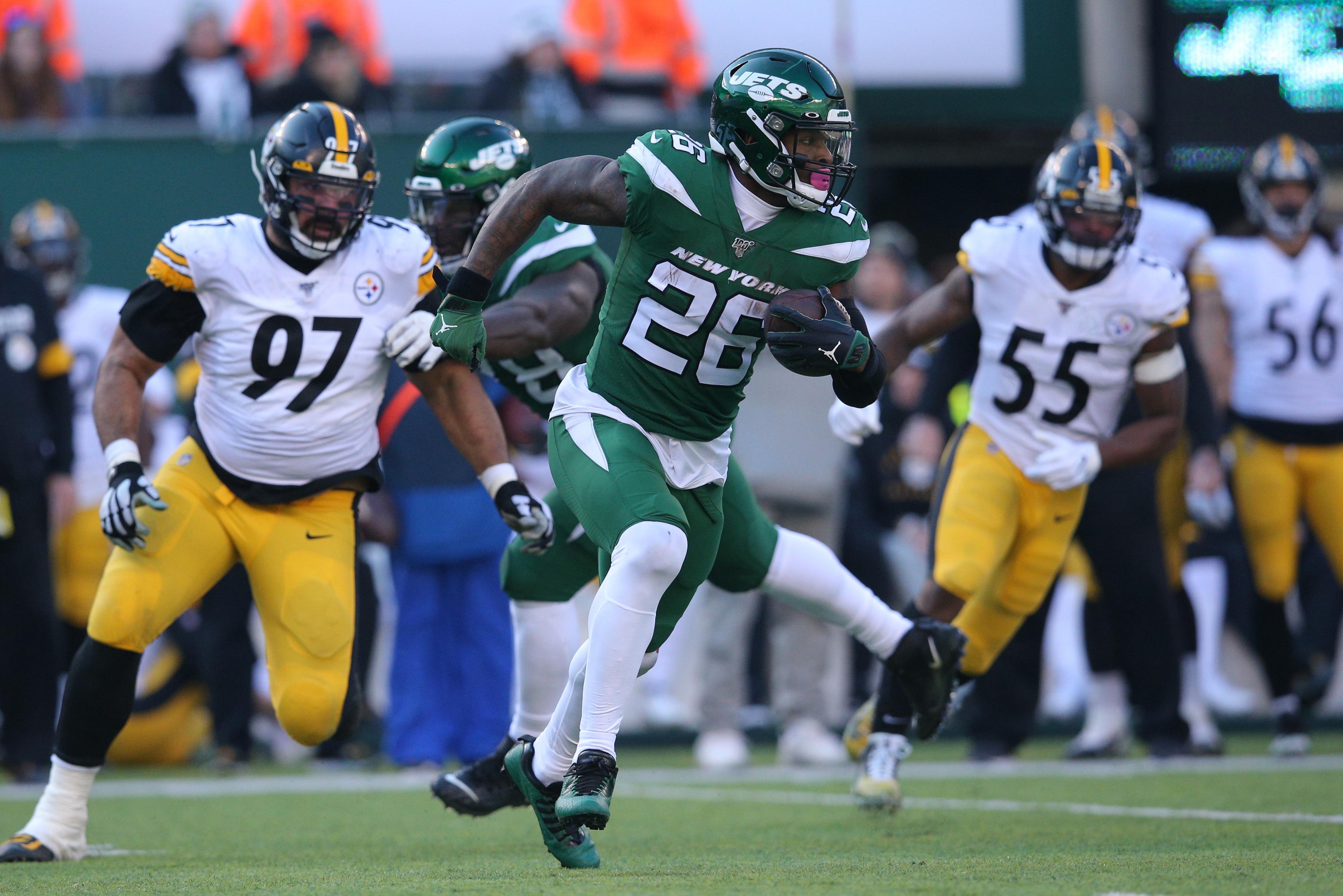 Dec 22, 2019; East Rutherford, New Jersey, USA; New York Jets running back Le'Veon Bell (26) runs the ball against the Pittsburgh Steelers during the second quarter at MetLife Stadium. Mandatory Credit: Brad Penner-USA TODAY Sports