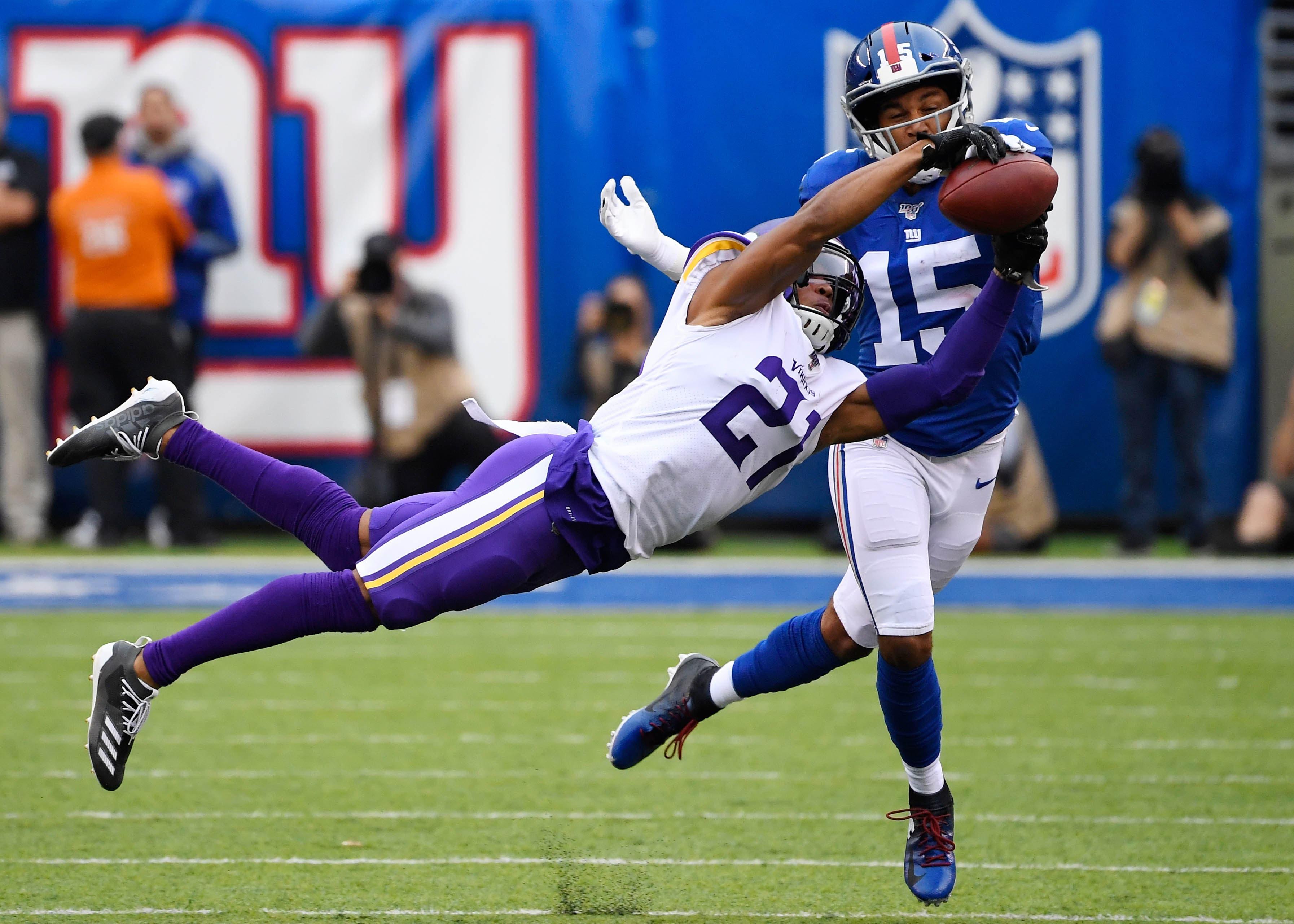 Oct 6, 2019; East Rutherford, NJ, USA; Minnesota Vikings cornerback Mike Hughes (21) breaks up a pass intended for New York Giants wide receiver Golden Tate (15) in the first half at MetLife Stadium. Mandatory Credit: Robert Deutsch-USA TODAY Sports / Robert Deutsch