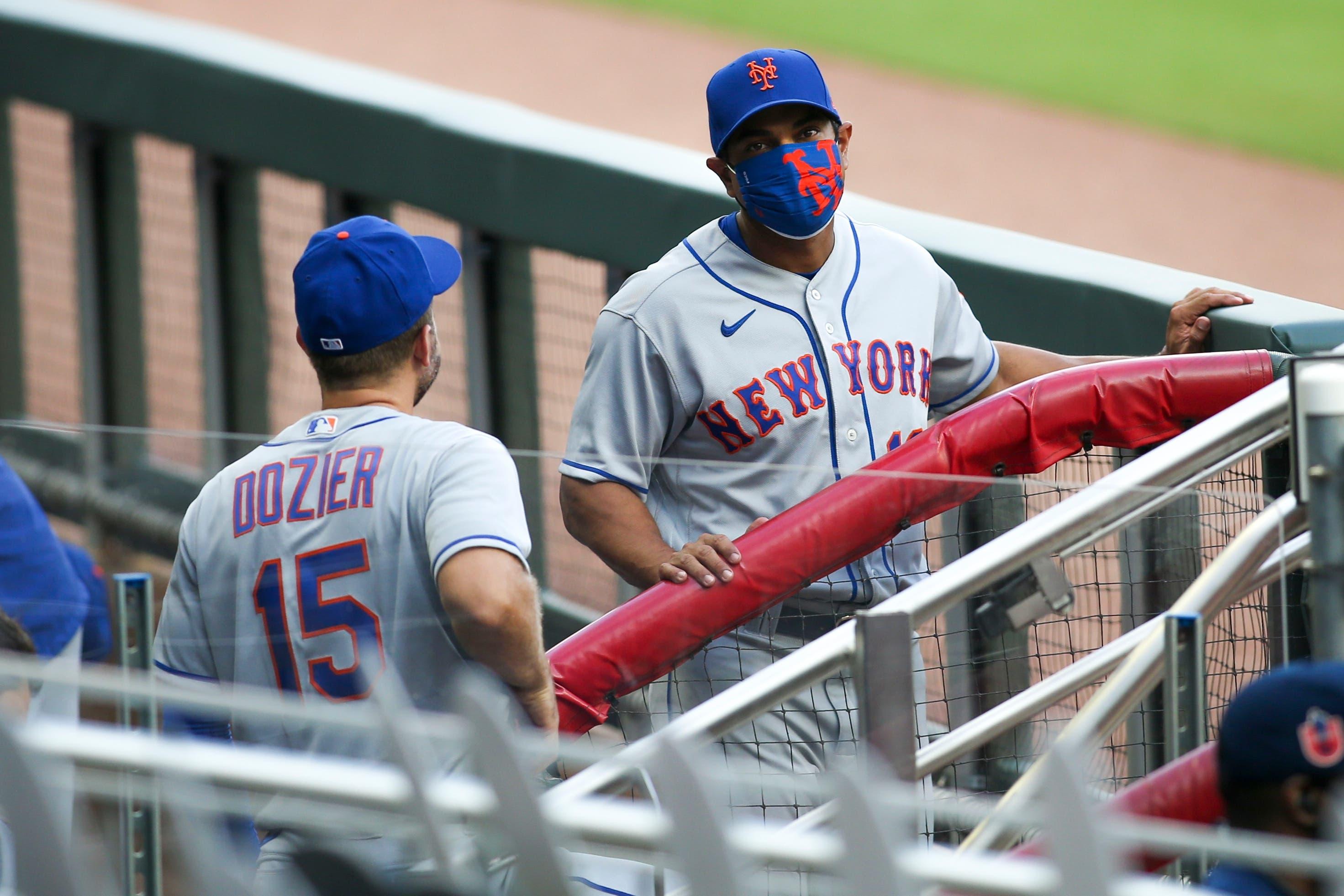 Aug 1, 2020; Atlanta, Georgia, USA; New York Mets manager Luis Rojas (19) talks to second baseman Brian Dozier (15) before a game against the Atlanta Braves at Truist Park. Mandatory Credit: Brett Davis-USA TODAY Sports / Brett Davis-USA TODAY Sports