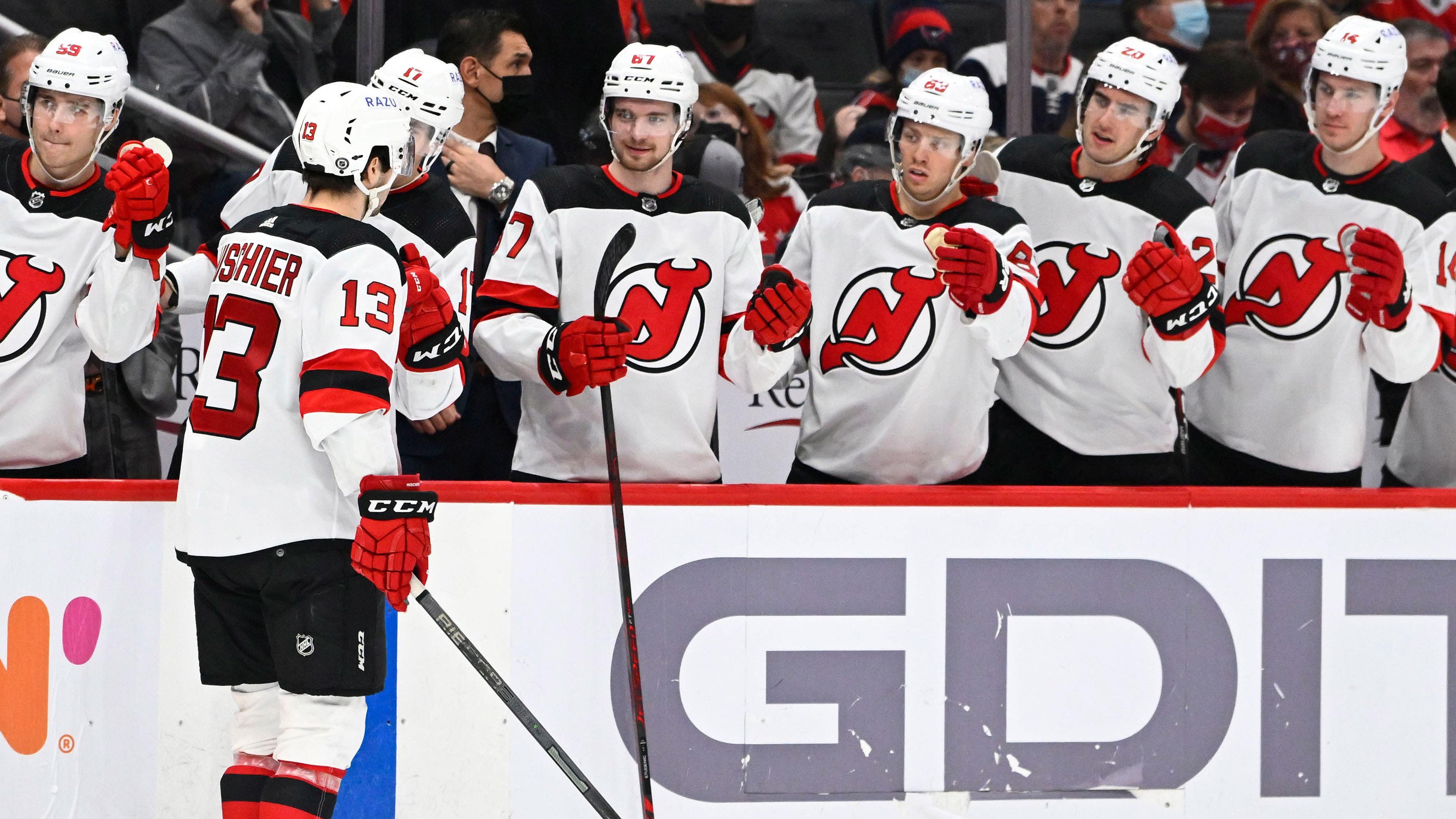 New Jersey Devils center Nico Hischier (13) is congratulated by teammates after scoring a goal against the Washington Capitals during the second period at Capital One Arena. / Brad Mills-USA TODAY Sports