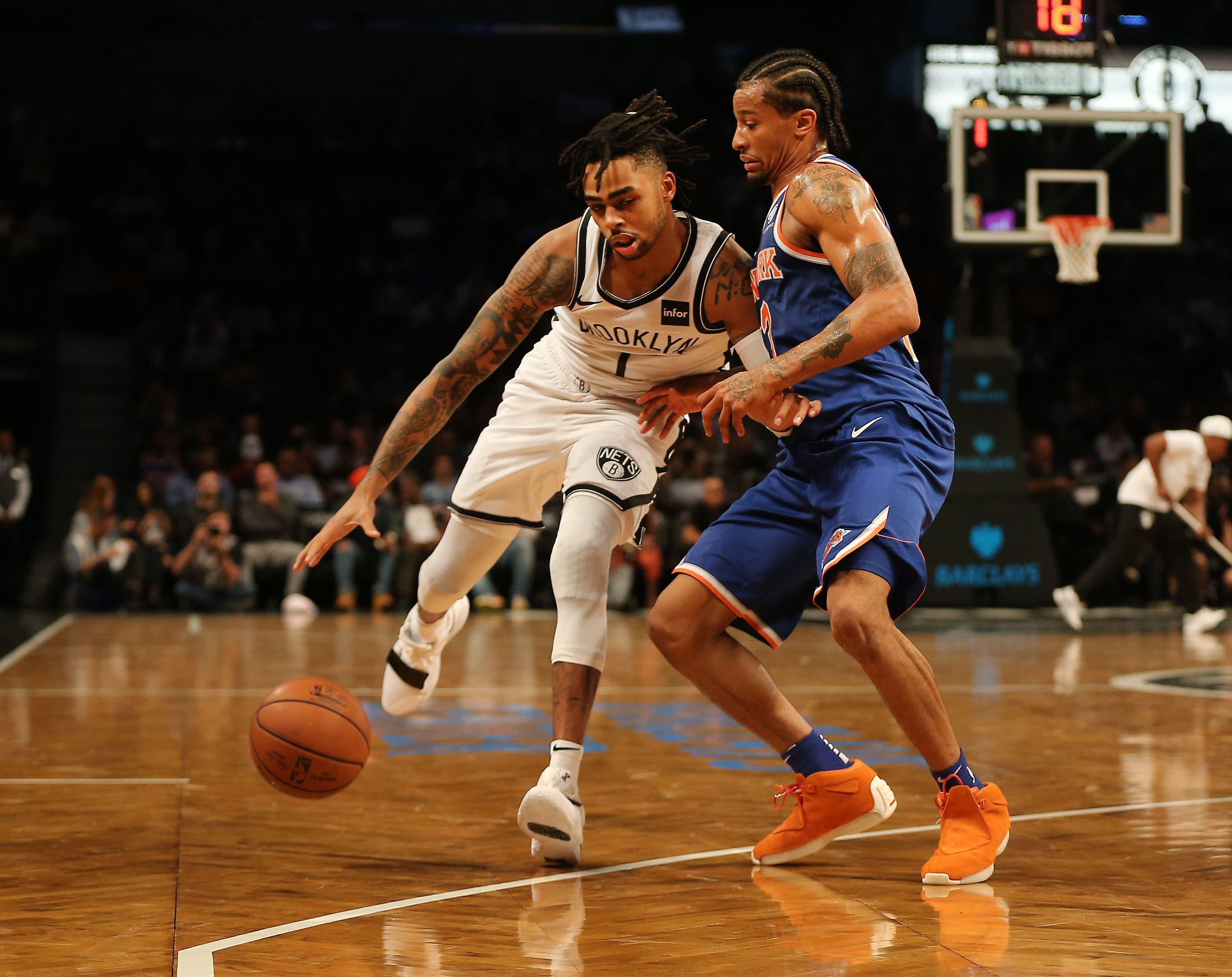 Oct 3, 2018; Brooklyn, NY, USA; Brooklyn Nets guard D'Angelo Russell (1) dribbles the ball while being defended by New York Knicks guard Trey Burke (23) during the first half of a preseason game at Barclays Center. Mandatory Credit: Andy Marlin-USA TODAY Sports / Andy Marlin