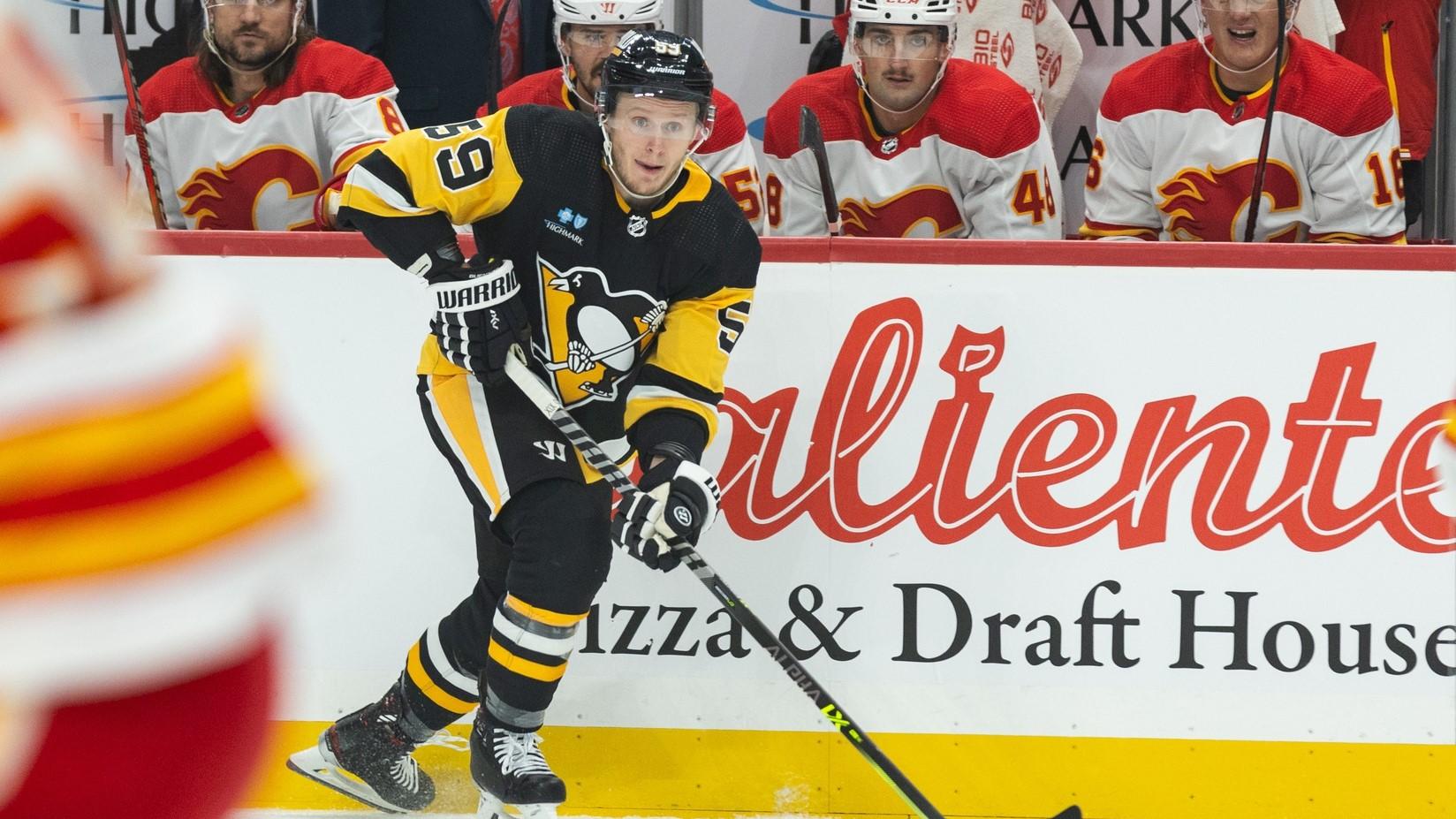 Oct 14, 2023; Pittsburgh, Pennsylvania, USA; Pittsburgh Penguins left winger Jake Guentzel (59) skates the puck into the Calgary Flames zone during the first period at PPG Paints Arena.