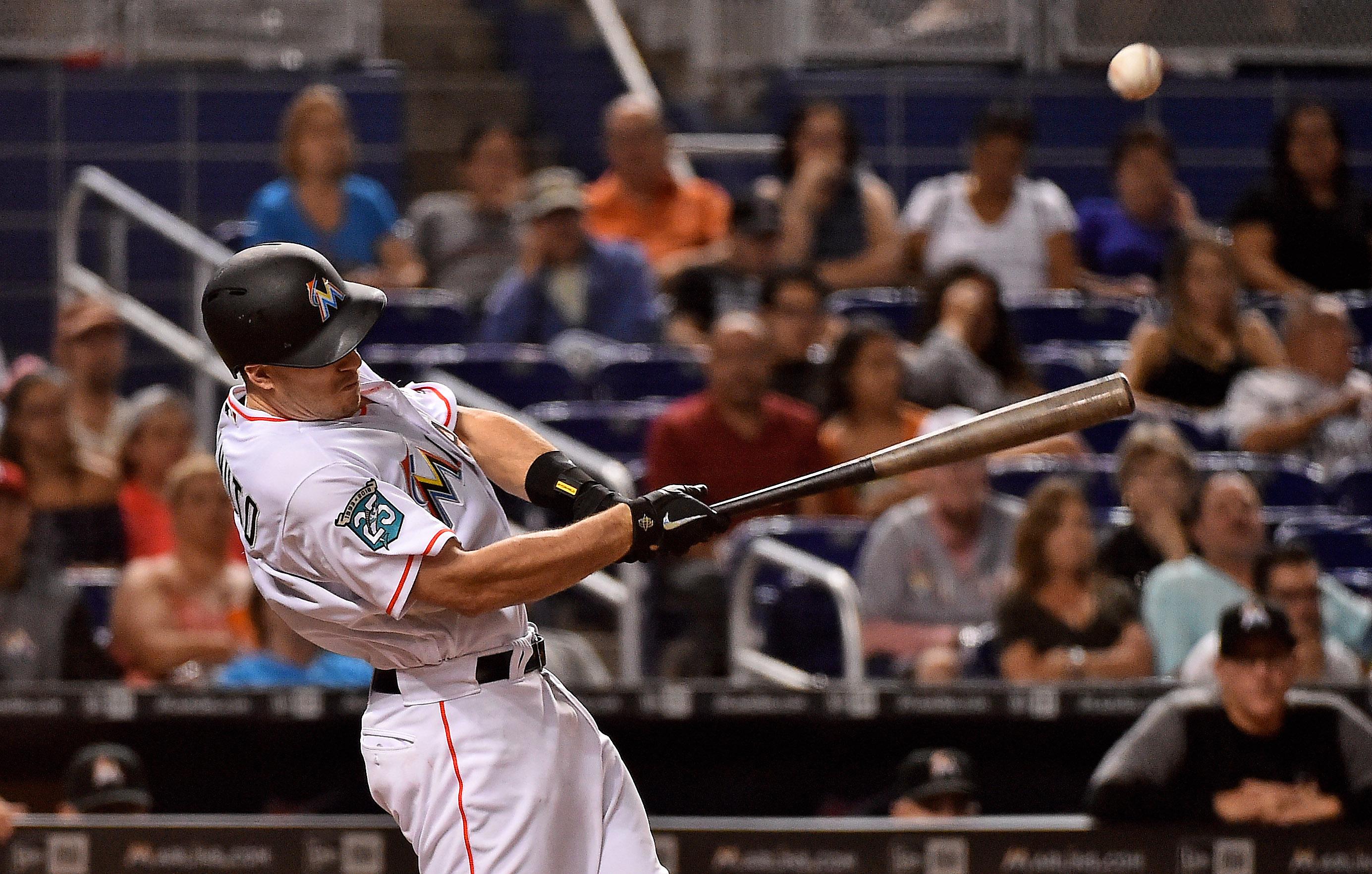 Sep 18, 2018; Miami, FL, USA; Miami Marlins catcher J.T. Realmuto (11) singles in a run in the fifth inning against the Washington Nationals at Marlins Park. Mandatory Credit: Jasen Vinlove-USA TODAY Sports