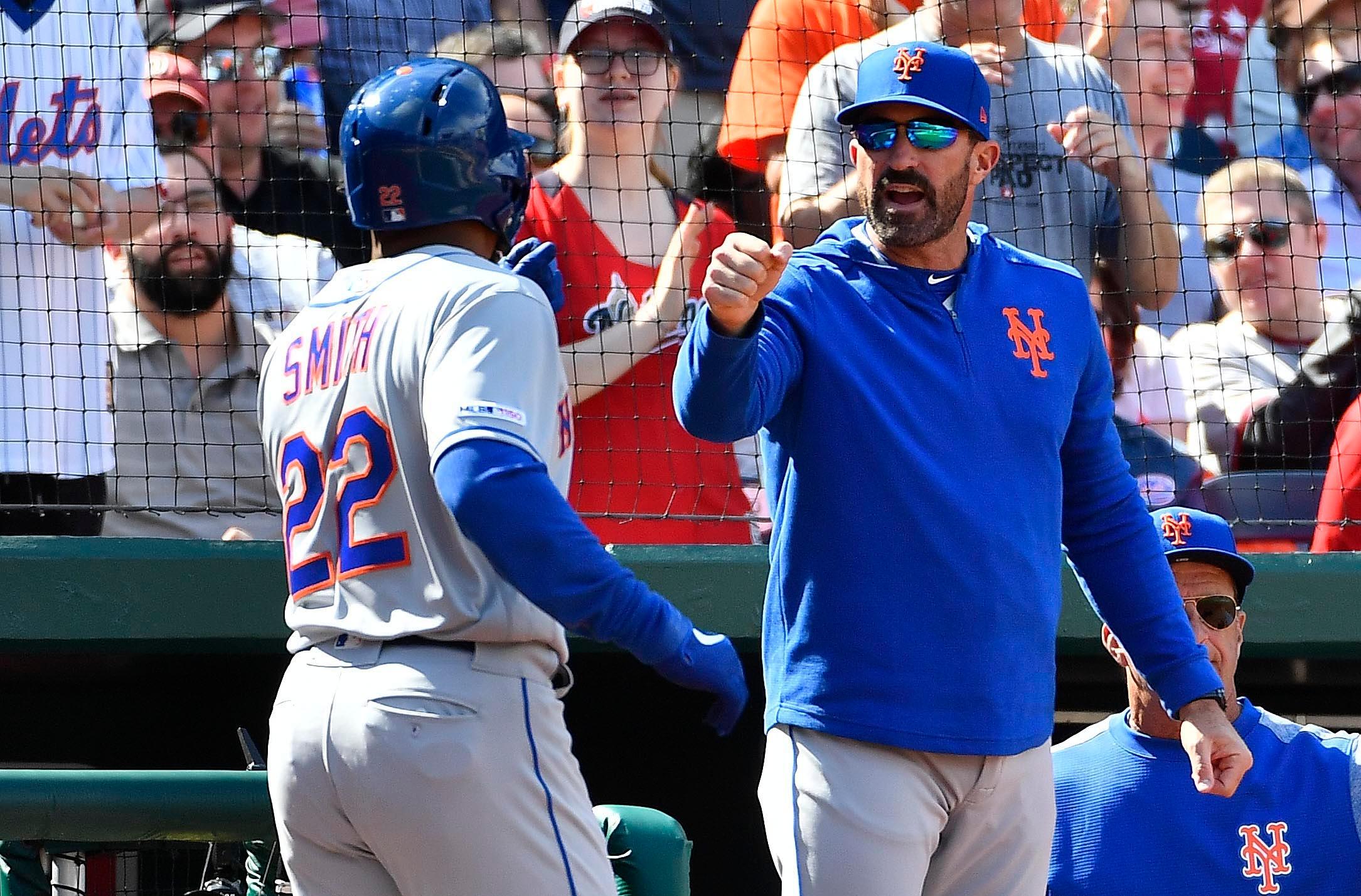 Mar 28, 2019; Washington, DC, USA; New York Mets first baseman Dominic Smith (22) is congratulated by New York Mets manager Mickey Callaway (36) after scoring a run against the Washington Nationals during the eighth inning at Nationals Park. Mandatory Credit: Brad Mills-USA TODAY Sports