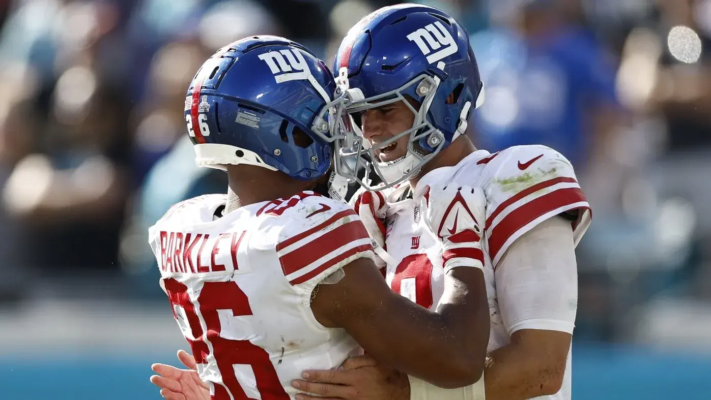 Oct 23, 2022; Jacksonville, Florida, USA; New York Giants quarterback Daniel Jones (8) celebrates with teammate running back Saquon Barkley (26) after scoring a touchdown against the Jacksonville Jaguars during the fourth quarter at TIAA Bank Field. / Douglas DeFelice-USA TODAY Sports