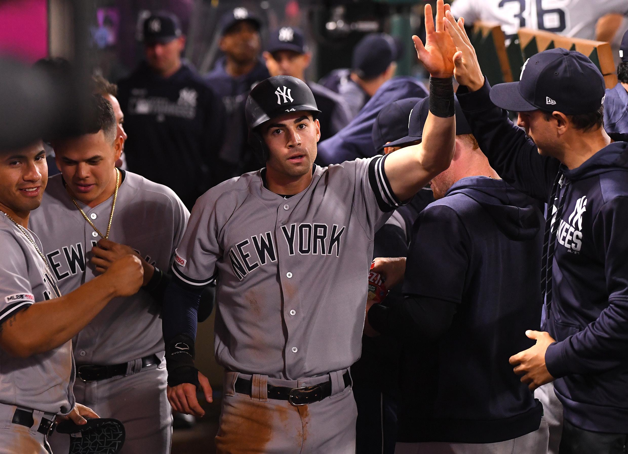 Apr 24, 2019; Anaheim, CA, USA; New York Yankees shortstop Tyler Wade (14) is greeted inthe dugout after scoring the go ahead run on a single by second baseman DJ LeMahieu (26) in the ninth inning of the game against the Los Angeles Angels at Angel Stadium of Anaheim. Mandatory Credit: Jayne Kamin-Oncea-USA TODAY Sports