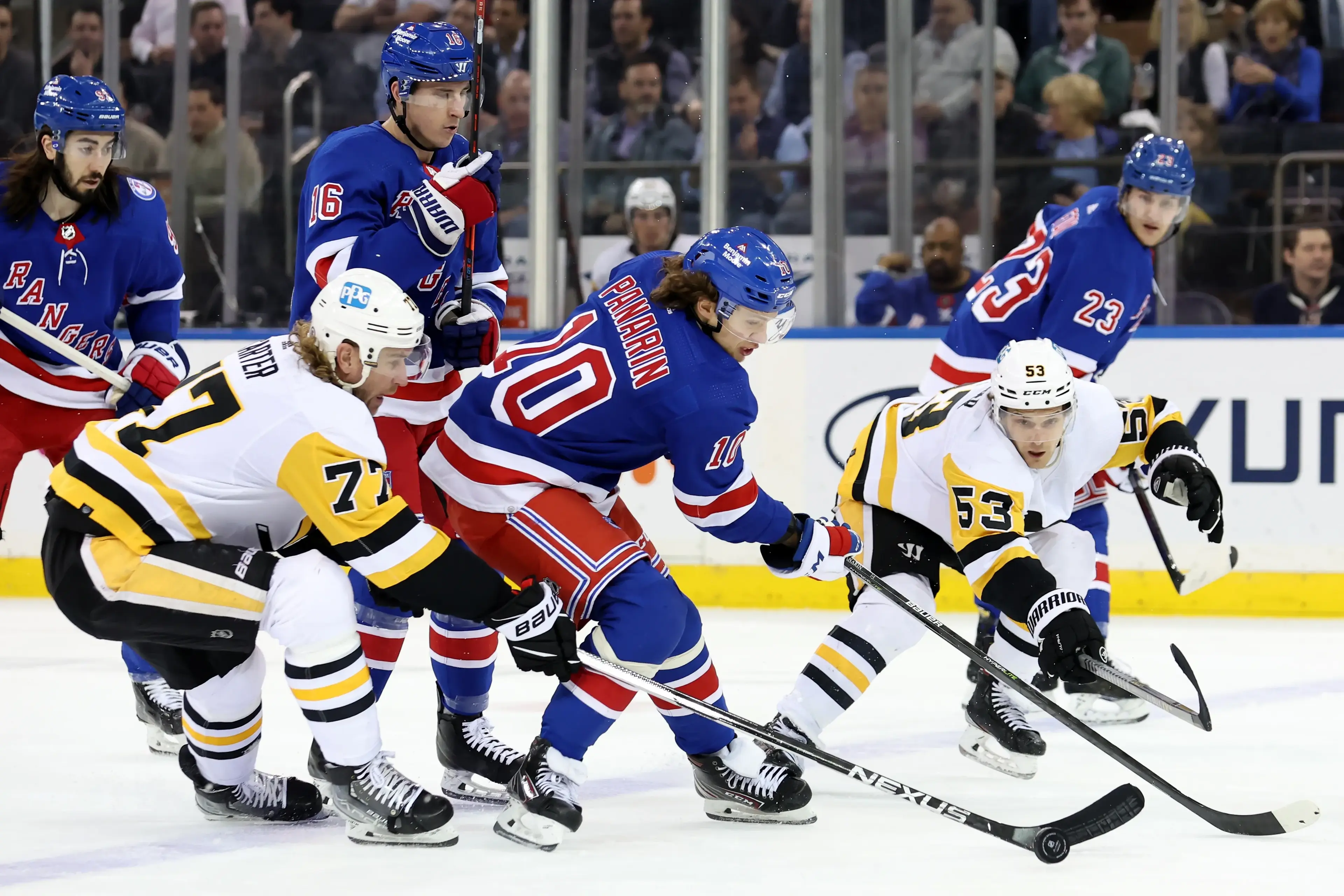 Apr 7, 2022; New York, New York, USA; New York Rangers left wing Artemi Panarin (10) fights for the puck against Pittsburgh Penguins center Jeff Carter (77) and center Teddy Blueger (53) during the first period at Madison Square Garden. Mandatory Credit: Brad Penner-USA TODAY Sports / © Brad Penner-USA TODAY Sports