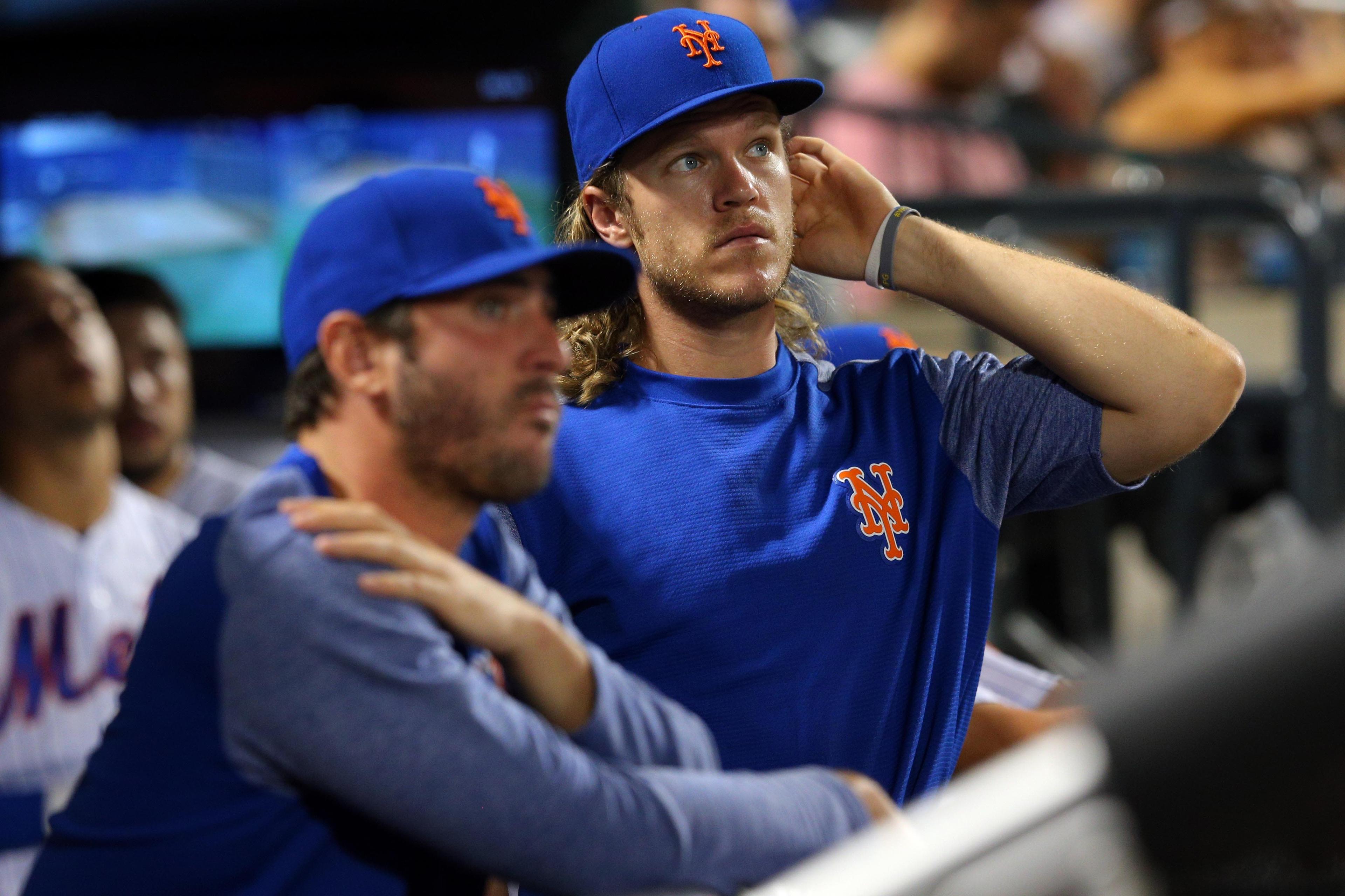 Jul 17, 2017; New York City, NY, USA; New York Mets injured starting pitchers Matt Harvey (33) and Noah Syndergaard (34) in the dugout during the eighth inning against the St. Louis Cardinals at Citi Field. Both pitchers threw pitches in the outfield before the game. Mandatory Credit: Brad Penner-USA TODAY Sports / Brad Penner