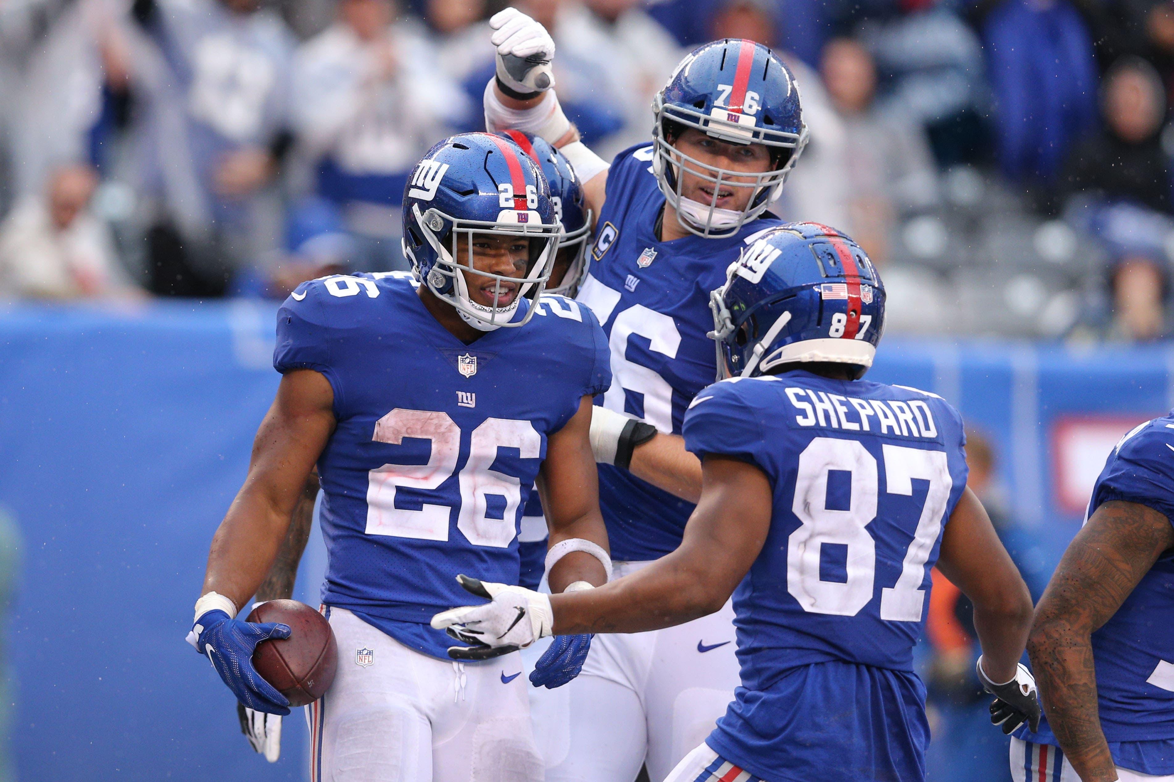 Sep 9, 2018; East Rutherford, NJ, USA; New York Giants running back Saquon Barkley (26) celebrates his touchdown against the Jacksonville Jaguars with offensive tackle Nate Solder (76) and wide receiver Sterling Shepard (87) during the fourth quarter at MetLife Stadium. The touchdown was the first of his NFL career. Mandatory Credit: Brad Penner-USA TODAY Sports / Brad Penner