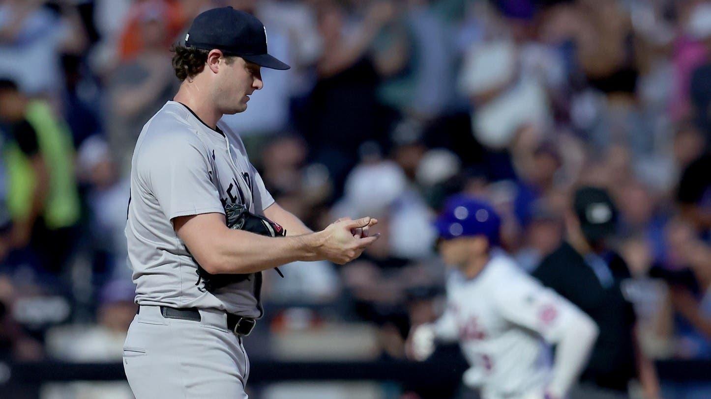 Jun 25, 2024; New York City, New York, USA; New York Yankees starting pitcher Gerrit Cole (45) reacts as New York Mets left fielder Brandon Nimmo (9) rounds the bases after hitting a two run home run during the fourth inning at Citi Field. / Brad Penner-USA TODAY Sports