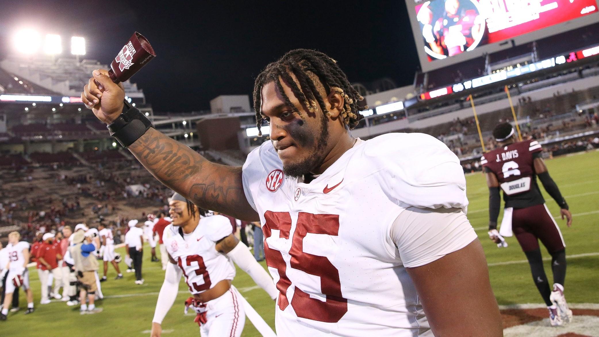 Sep 30, 2023; Starkville, Mississippi, USA; Alabama Crimson Tide offensive lineman JC Latham (65) celebrates with a cow bell in Davis Wade Stadium at Mississippi State University. Alabama defeated Mississippi State 40-17. / Gary Cosby Jr.-Tuscaloosa News