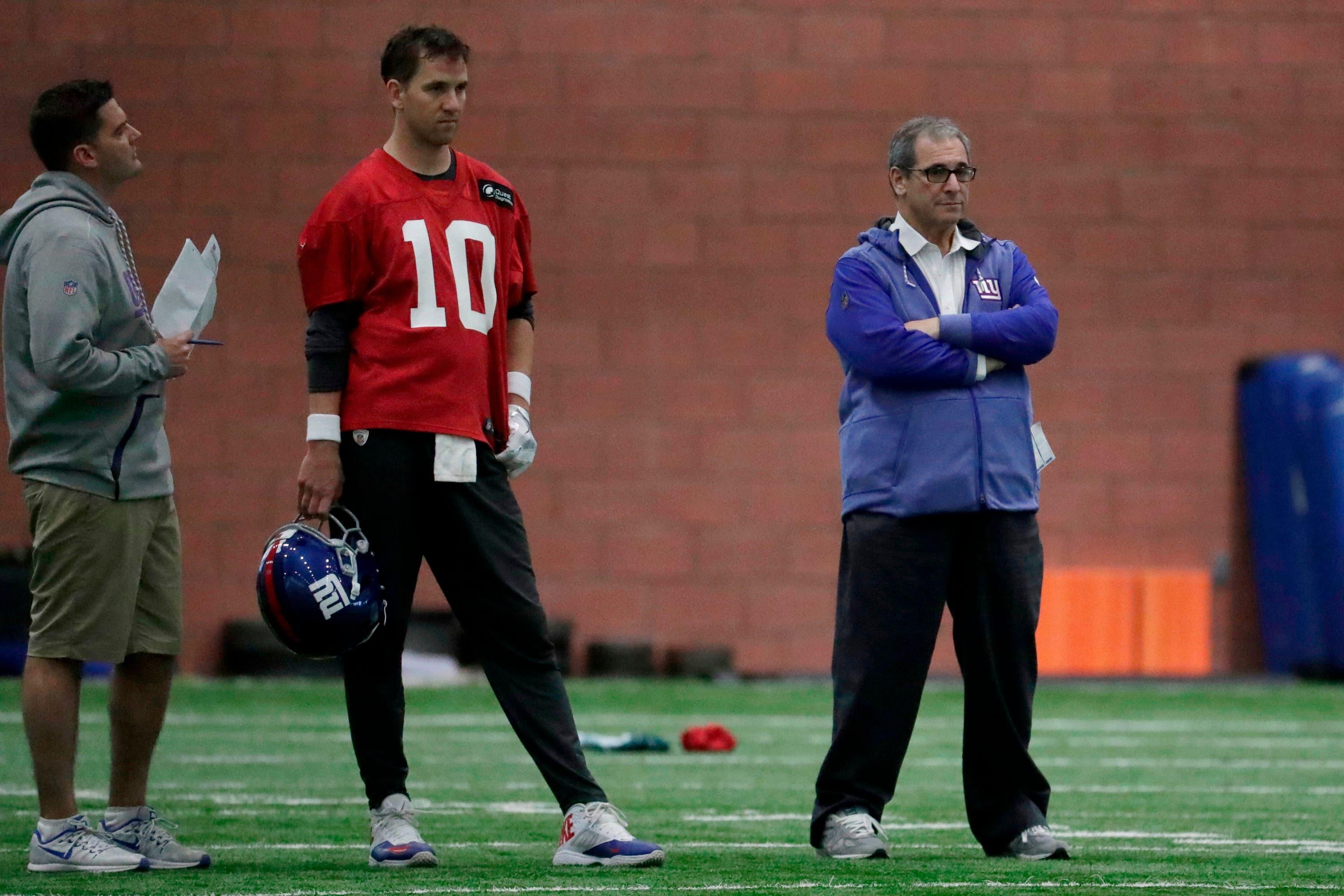 New York Giants quarterback Eli Manning (10) stands next to general manager Dave Gettleman during NFL football training camp, Wednesday, April 25, 2018, in East Rutherford, N.J. (AP Photo/Julio Cortez) / Julio Cortez/AP