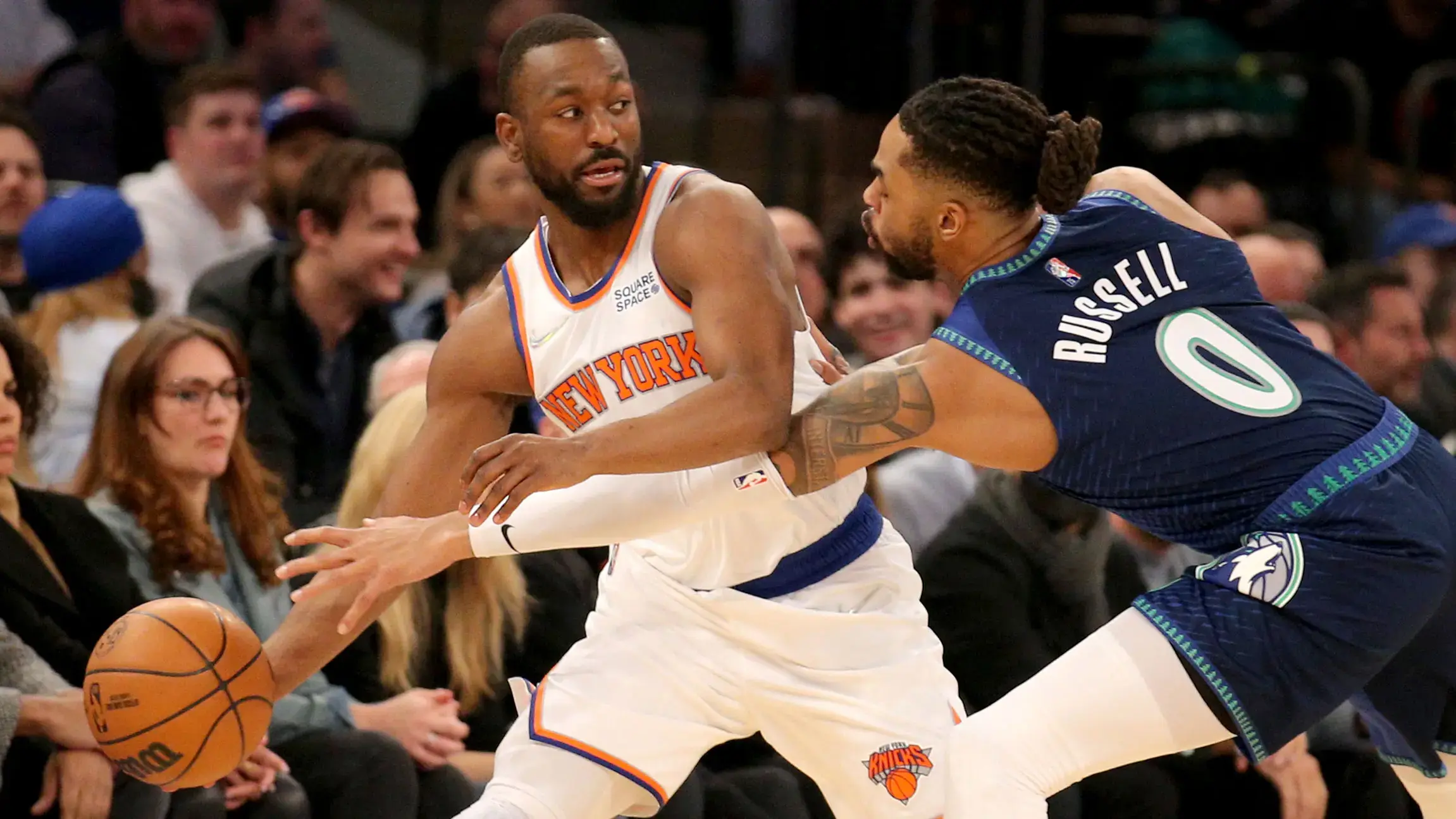 Jan 18, 2022; New York, New York, USA; New York Knicks guard Kemba Walker (8) controls the ball against Minnesota Timberwolves guard D'Angelo Russell (0) and forward Jarred Vanderbilt (8) during the first quarter at Madison Square Garden. / Brad Penner-USA TODAY Sports