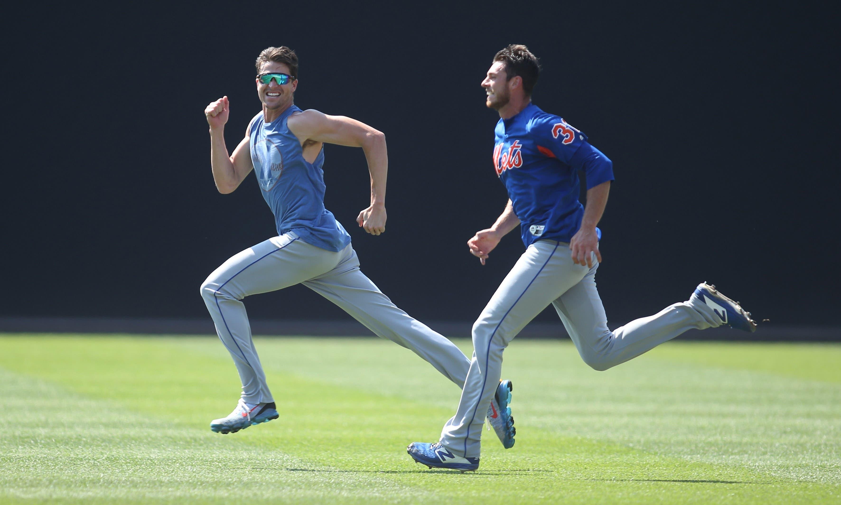 Aug 4, 2019; Pittsburgh, PA, USA; New York Mets pitchers Jacob deGrom (left) and Steven Matz (32) race in the outfield before the game against the Pittsburgh Pirates at PNC Park. Mandatory Credit: Charles LeClaire-USA TODAY Sports / Charles LeClaire