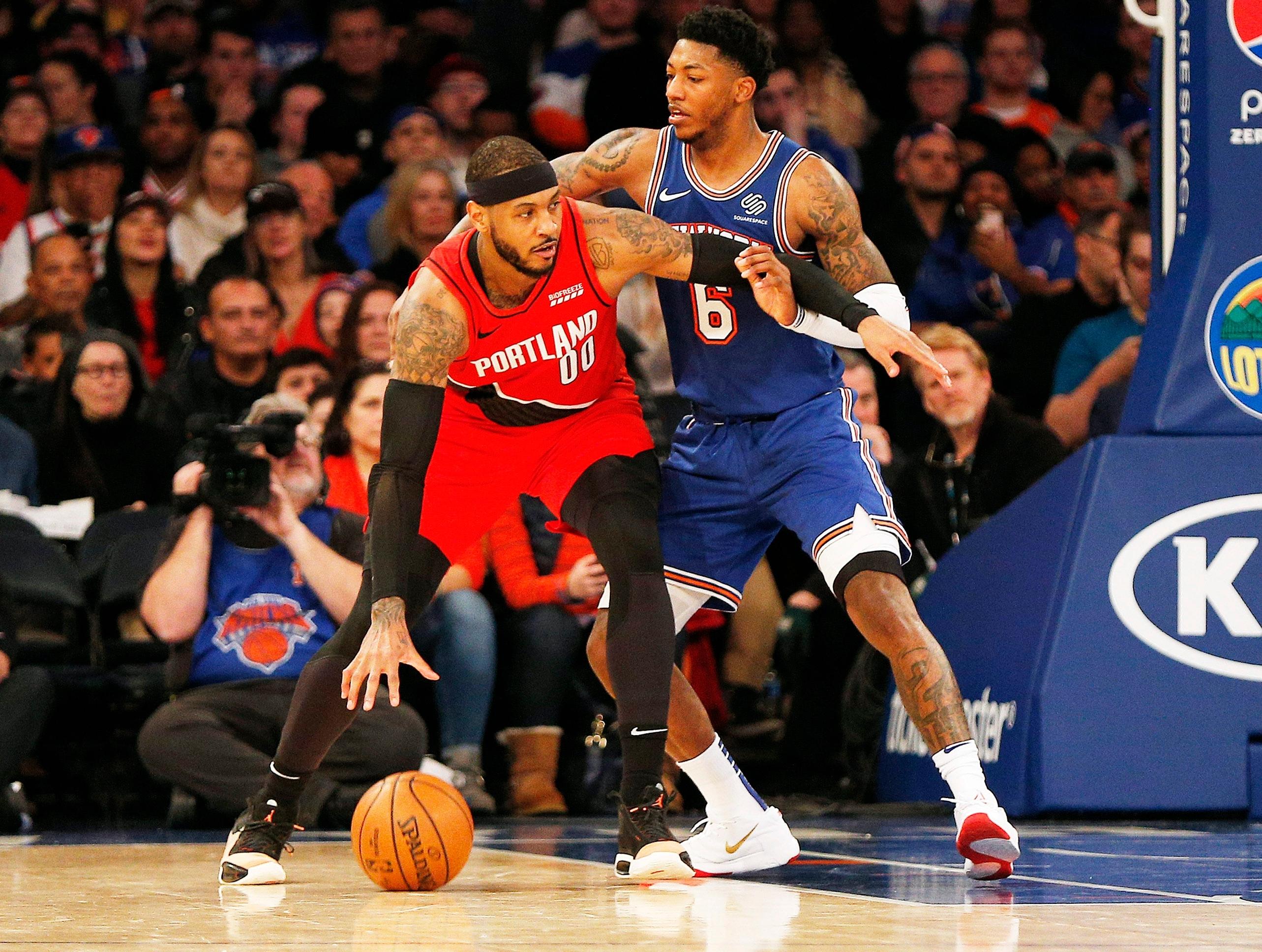 Jan 1, 2020; New York, New York, USA; Portland Trail Blazers forward Carmelo Anthony (00) dribbles the ball against New York Knicks guard Elfrid Payton (6) during the second half at Madison Square Garden. Mandatory Credit: Andy Marlin-USA TODAY Sports