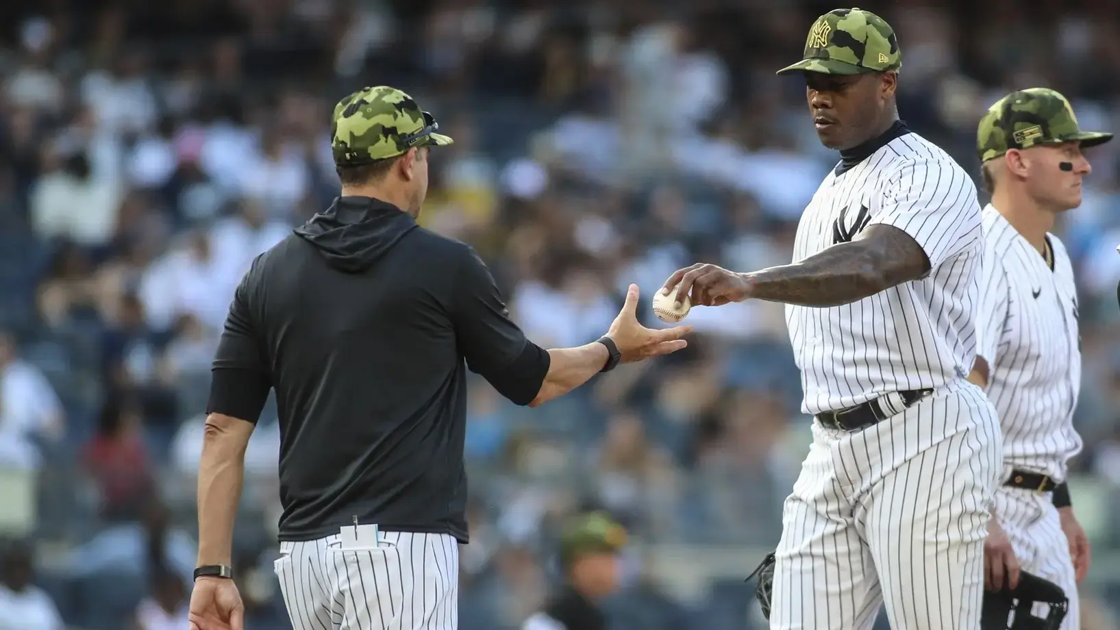 May 22, 2022; Bronx, New York, USA; New York Yankees relief pitcher Aroldis Chapman (54) is taken out by manager Aaron Boone (17) in the ninth inning after blowing the save against the Chicago White Sox at Yankee Stadium. / Wendell Cruz-USA TODAY Sports