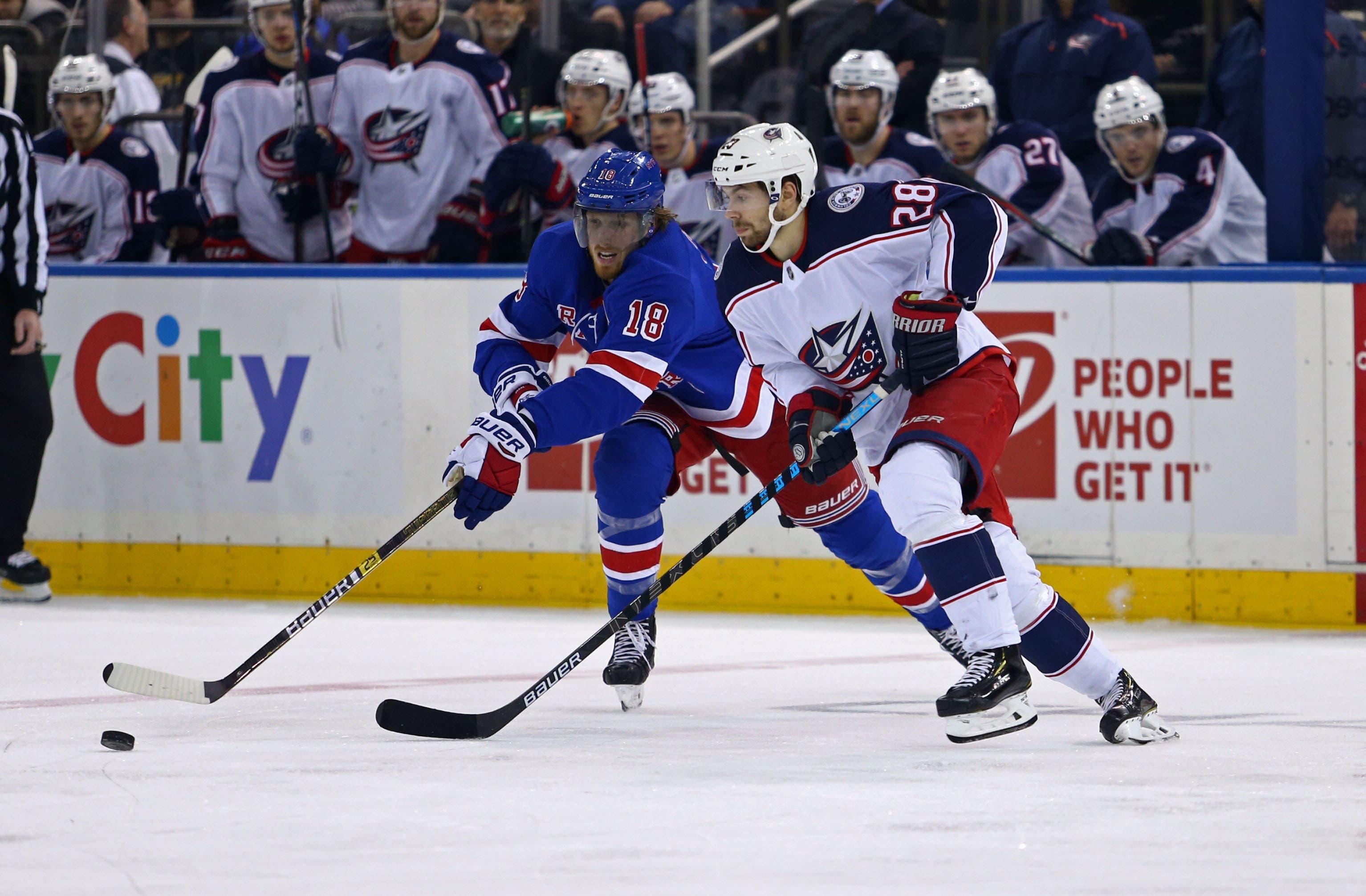 Dec 27, 2018; New York, NY, USA; New York Rangers defenseman Marc Staal (18) and Columbus Blue Jackets right wing Oliver Bjorkstrand (28) fight for the puck during the second period at Madison Square Garden. Mandatory Credit: Danny Wild-USA TODAY Sports / Danny Wild